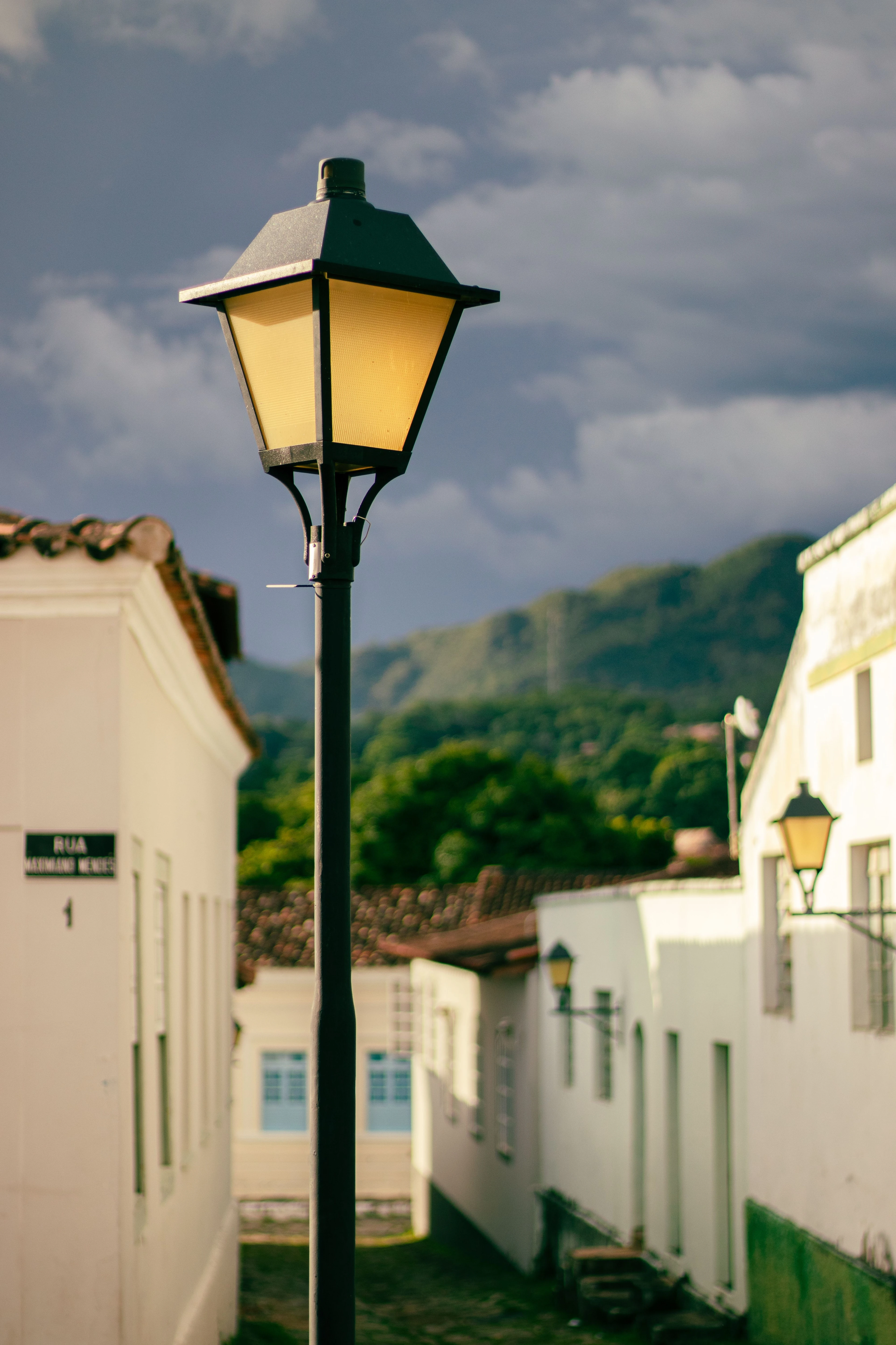 A yellow street lamp and colonial lane in Goiás town, shown as state cultural context.