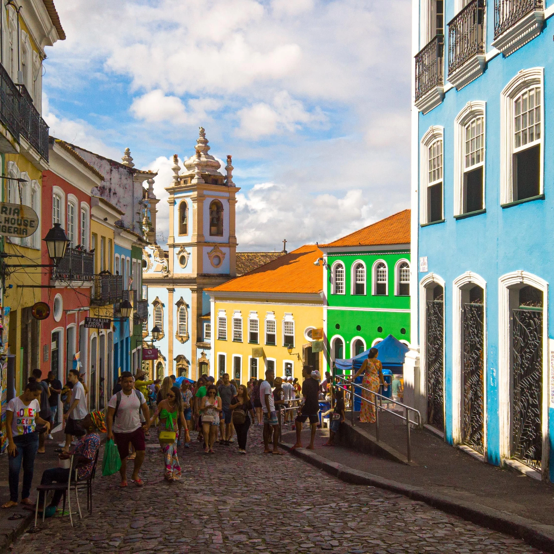 People walk among colorful colonial façades in Salvador’s Pelourinho.