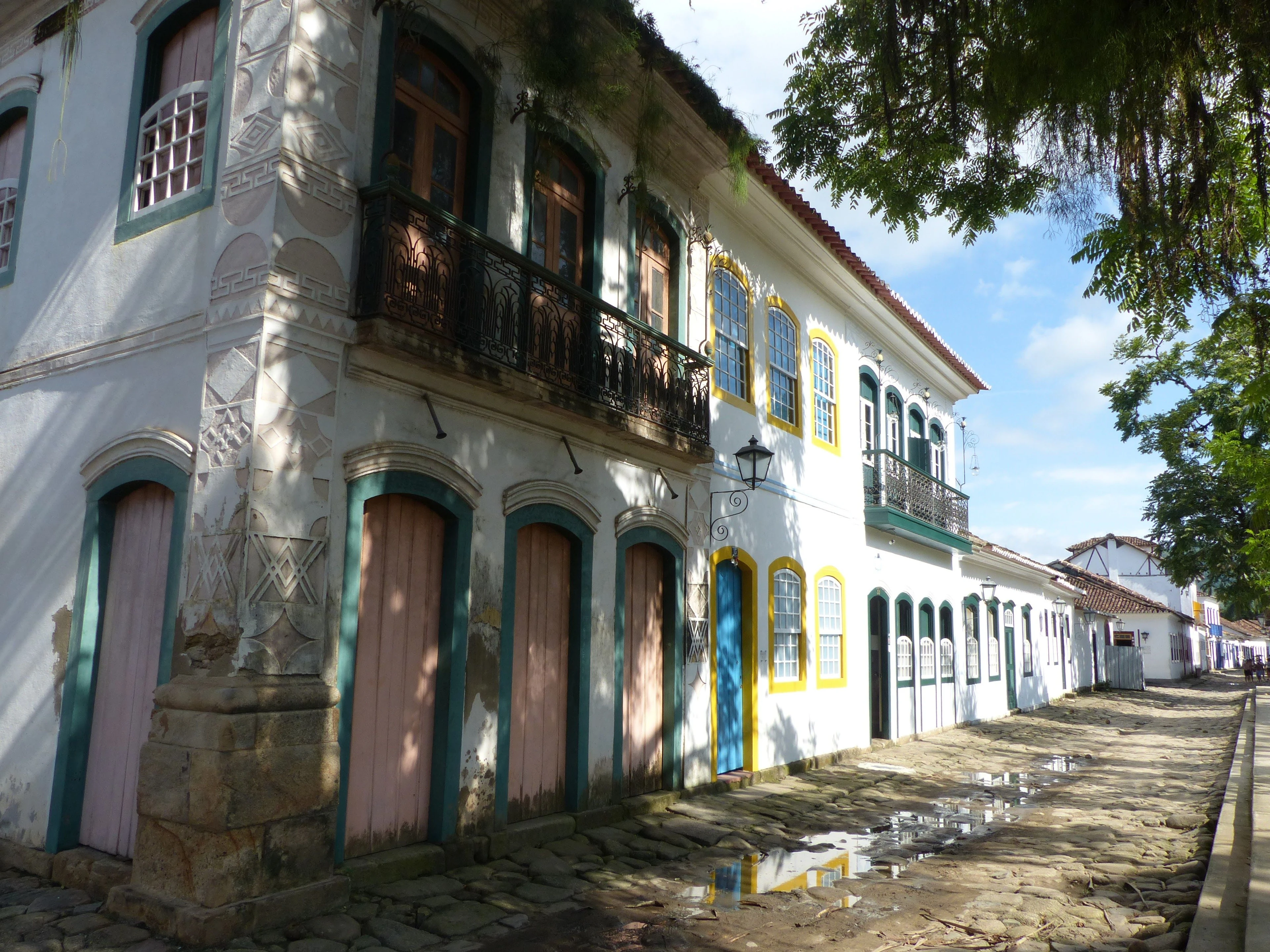 White historic houses with colorful trim along a Paraty street