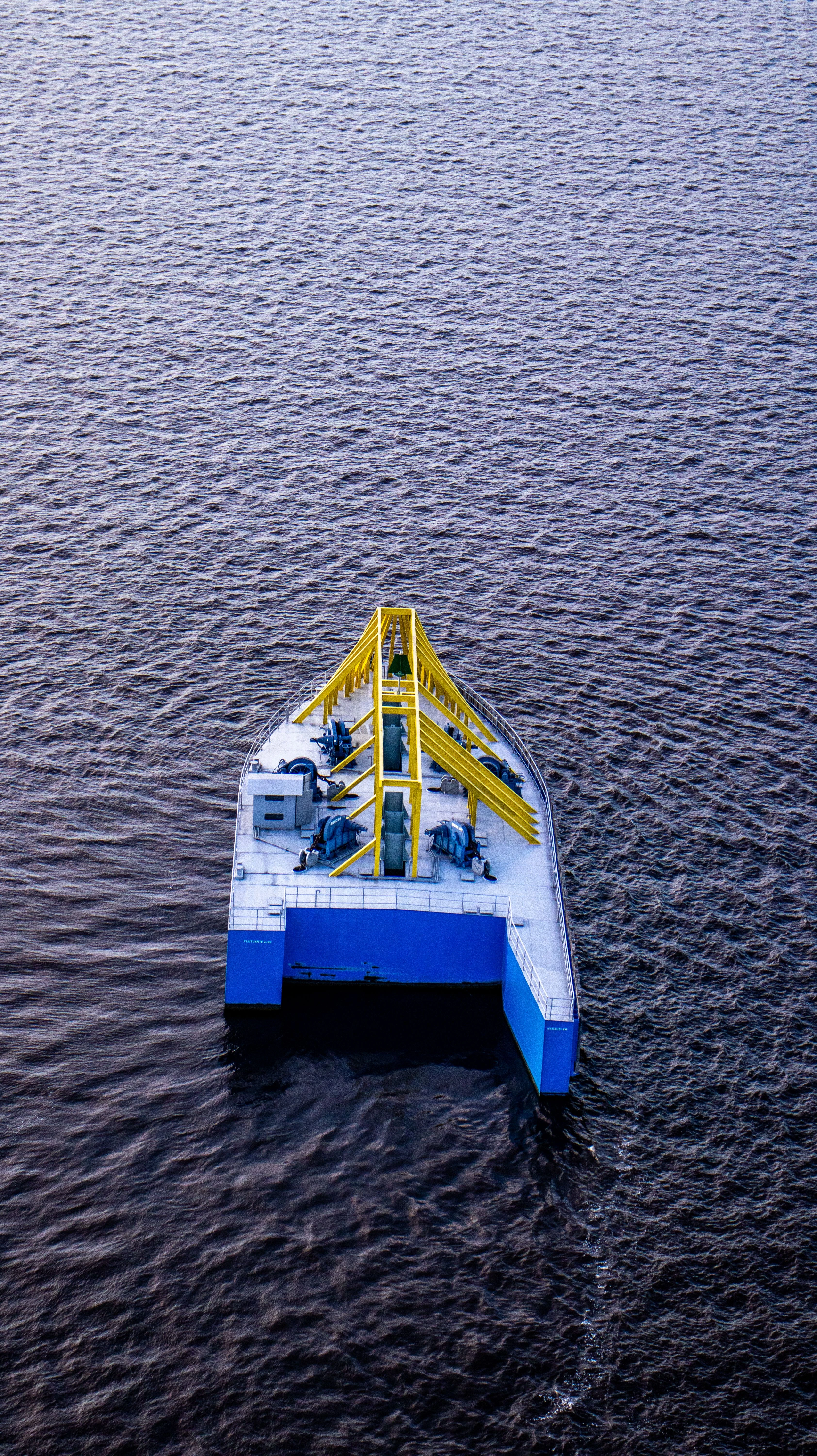 Blue and yellow working vessel seen from above on the Rio Negro at Manaus