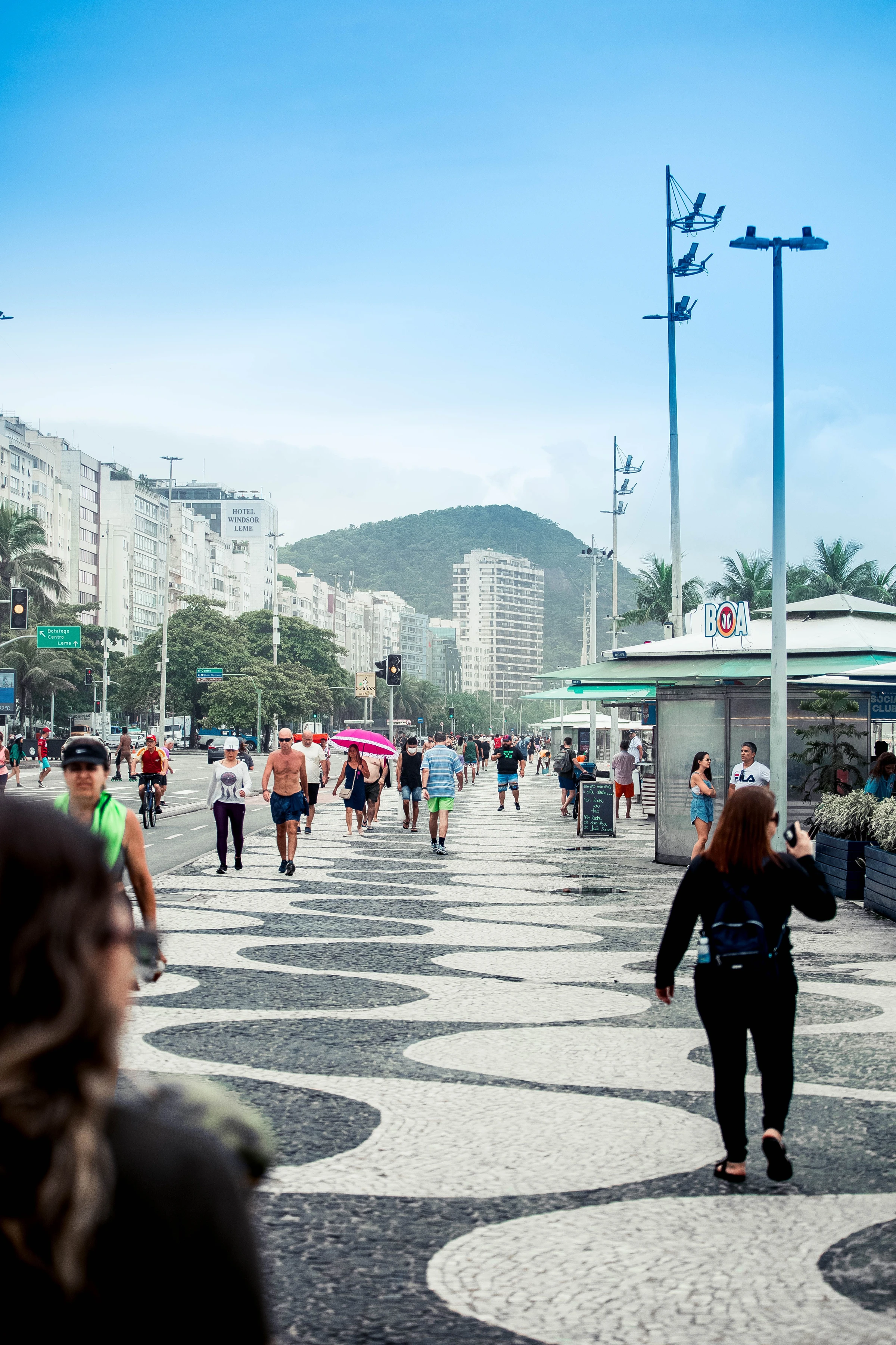 People and vendors on Copacabana’s black-and-white mosaic promenade