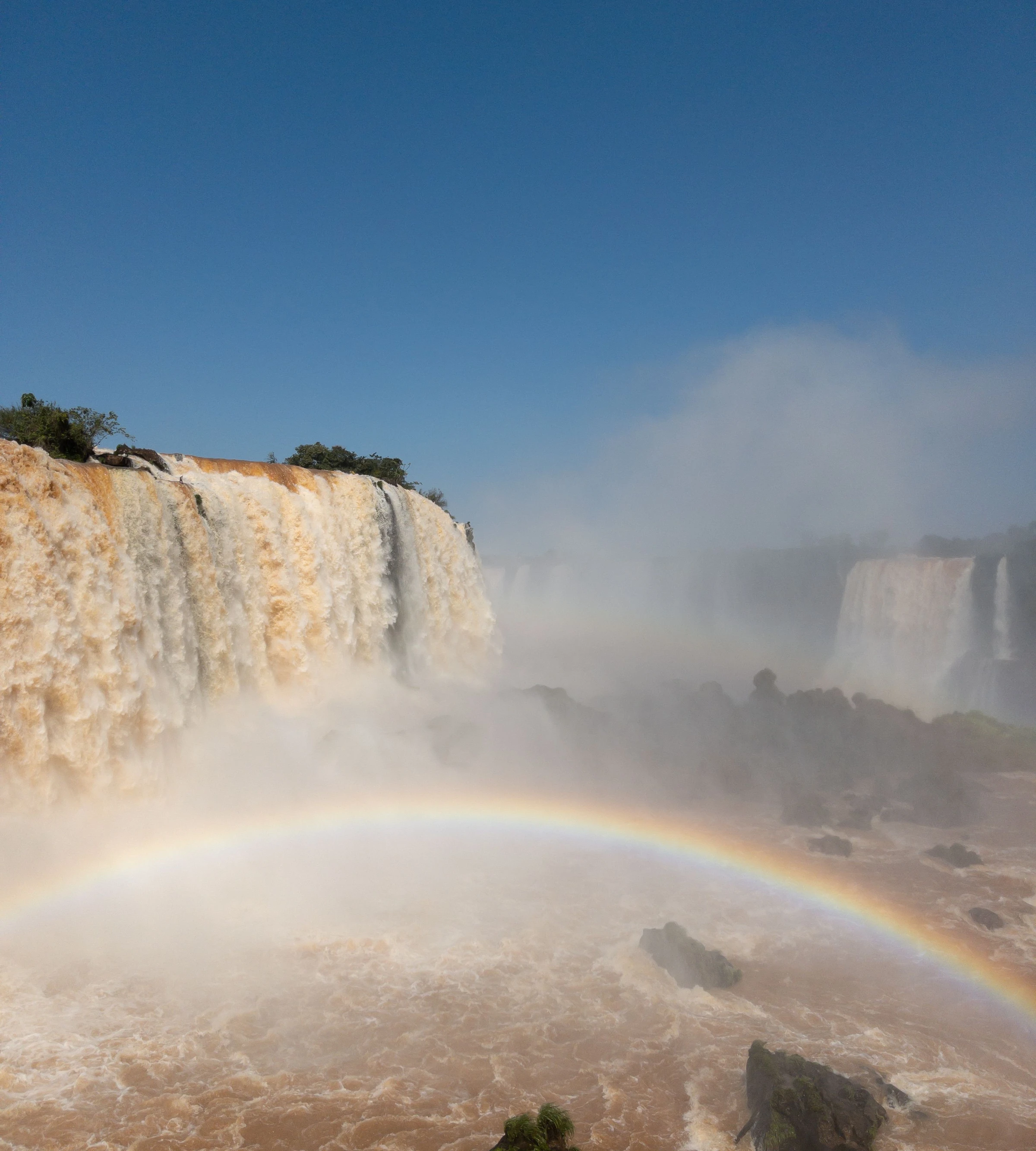 A rainbow arches through the spray below Iguaçu Falls.