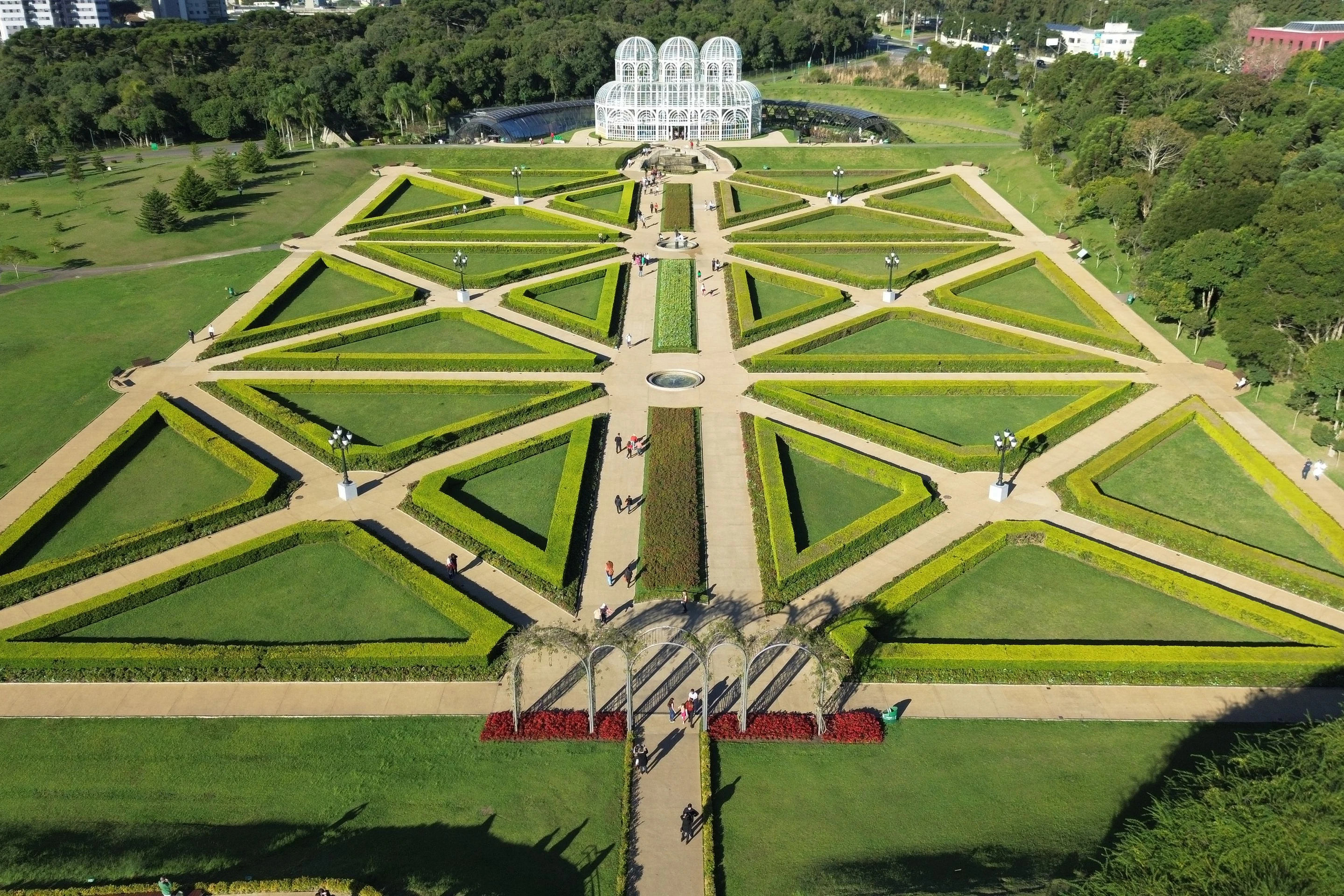 An elevated view of the formal garden and glasshouse at Curitiba's Jardim Botânico.