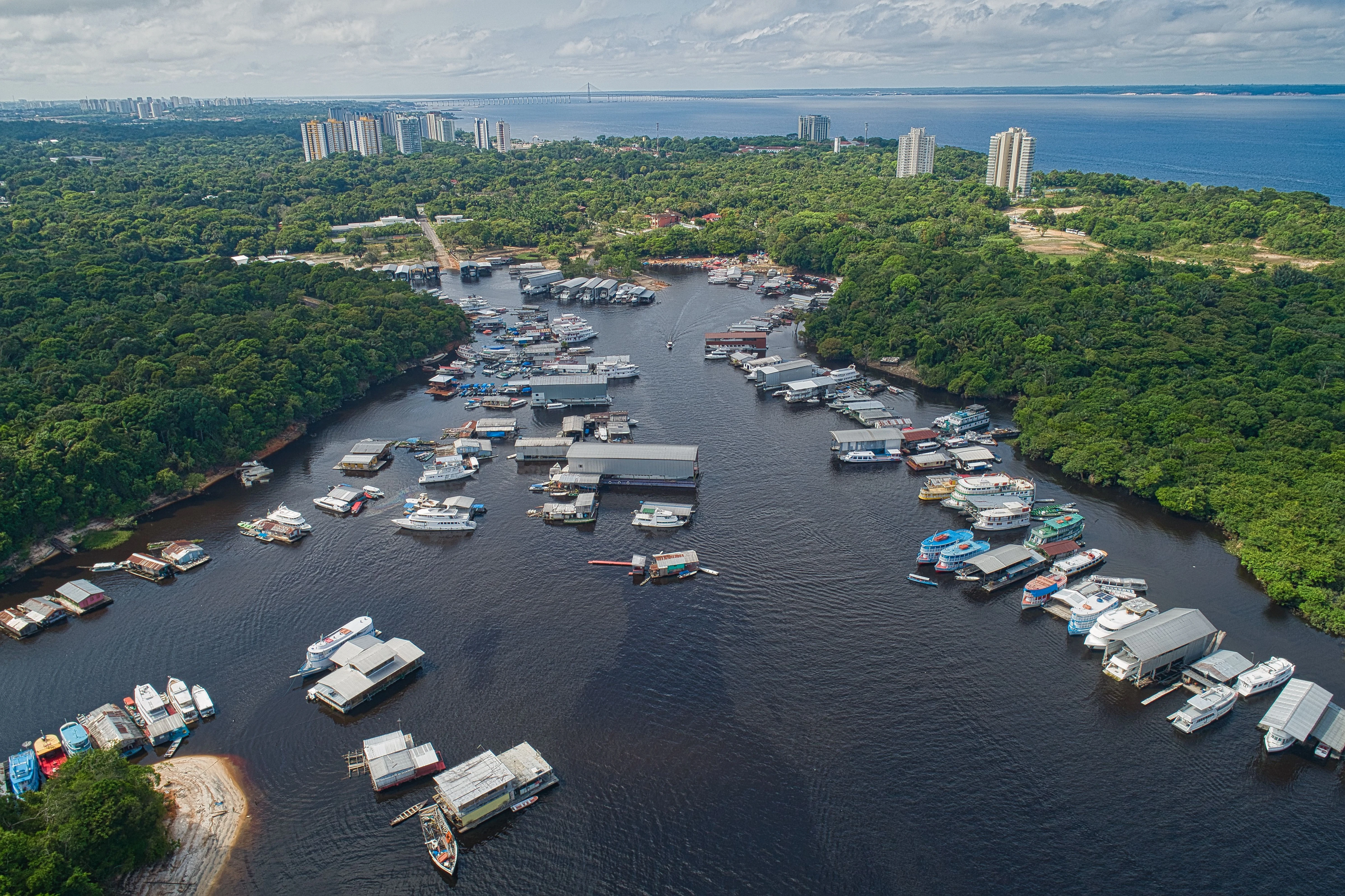 Aerial view of boats and wooded shoreline at Marina do Davi in Manaus