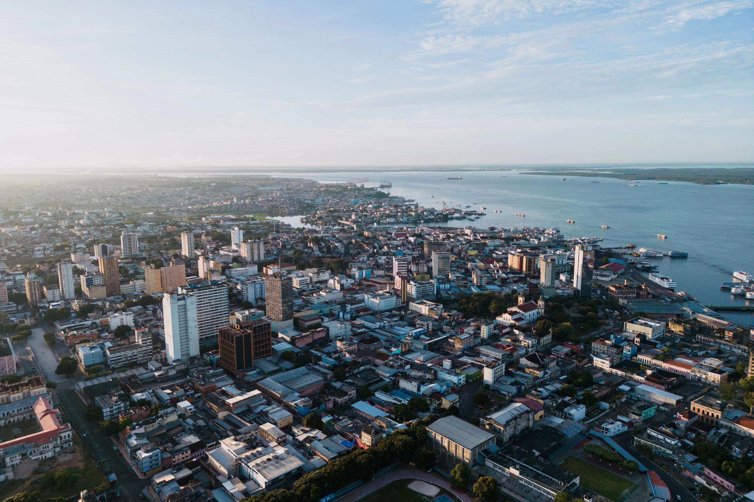 An aerial view across Manaus toward the broad Rio Negro.