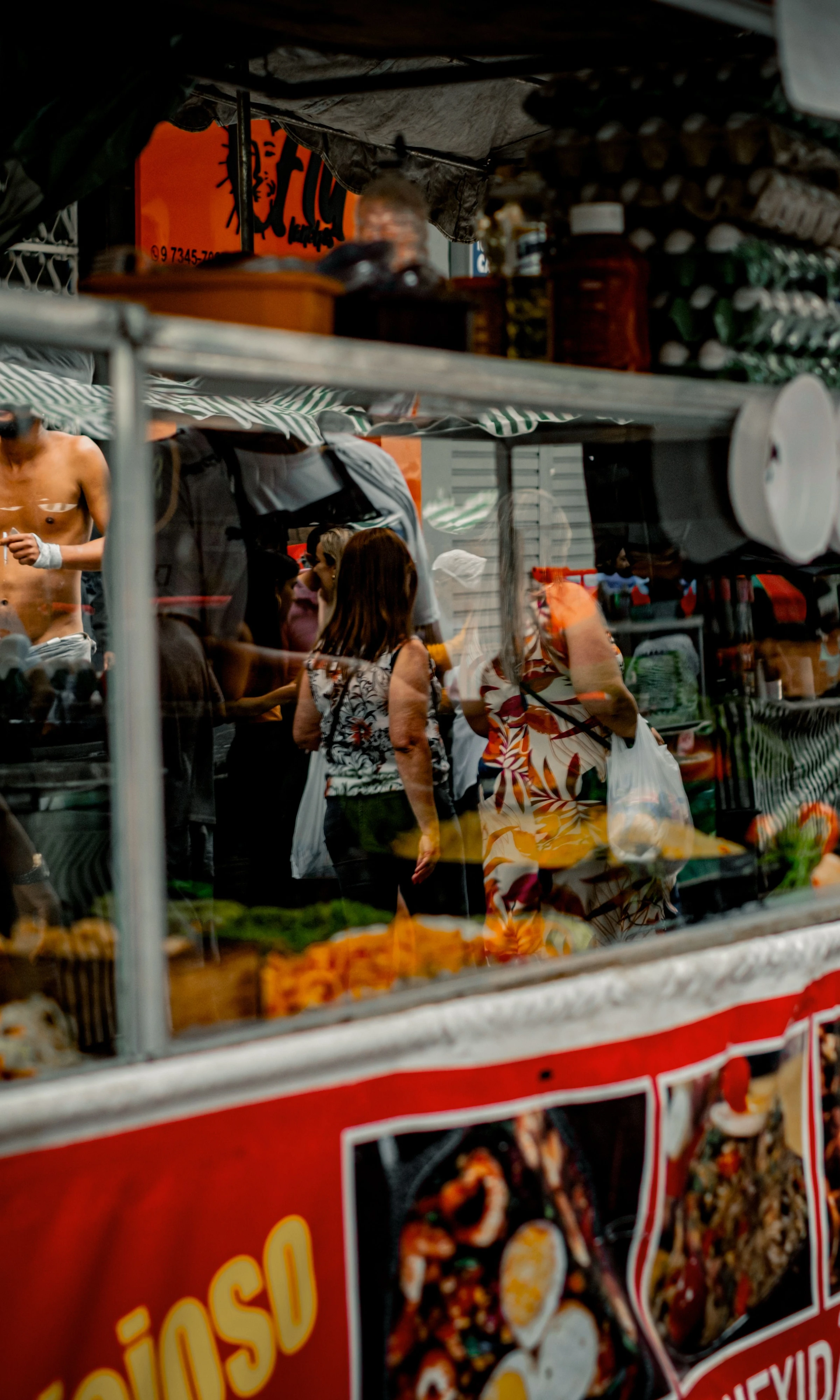Customers gather at a red street-food stall in Belo Horizonte.