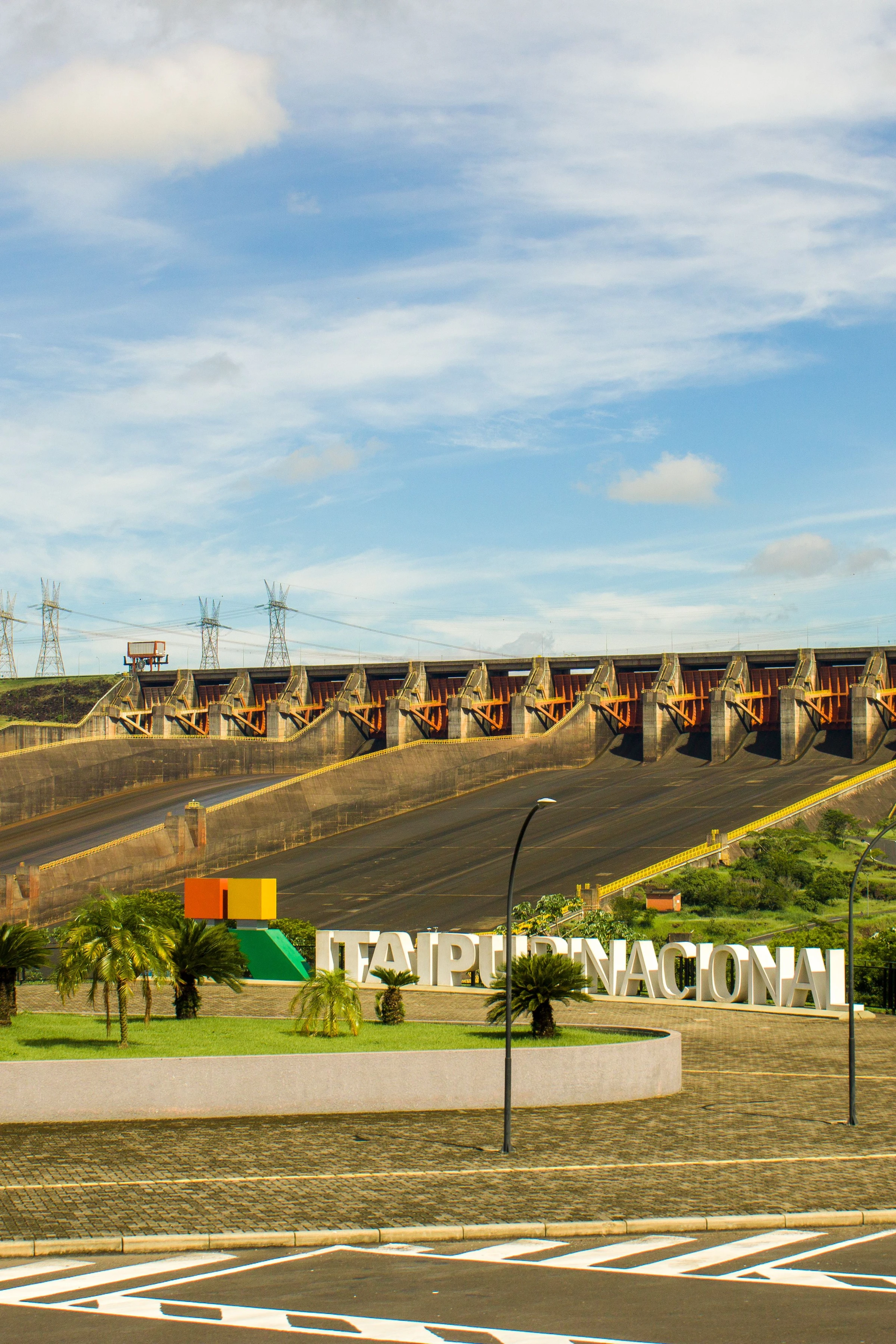 The monumental concrete spillway of Itaipu beneath a clear blue sky.