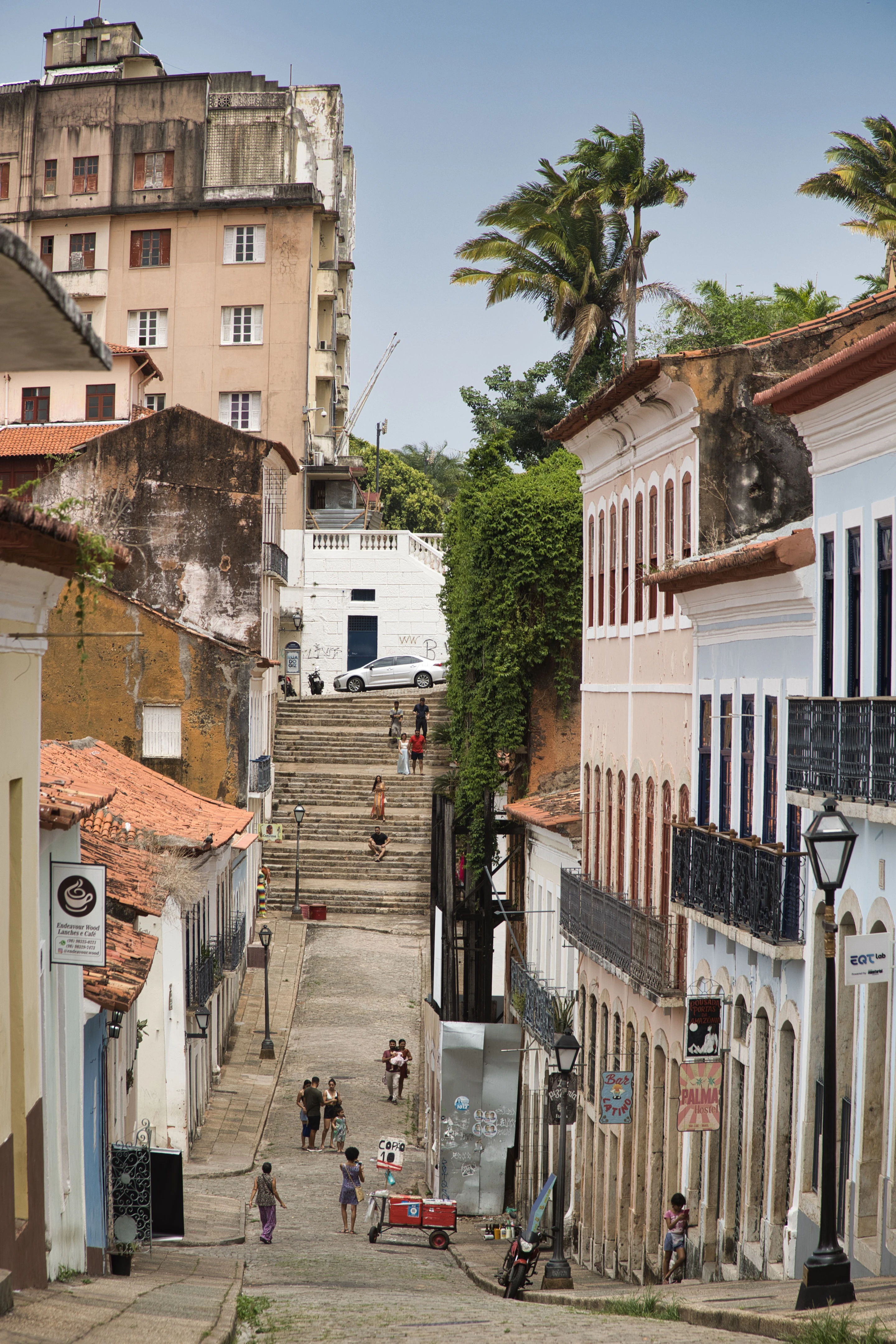 Colorful historic façades, steps and palms along a street in São Luís