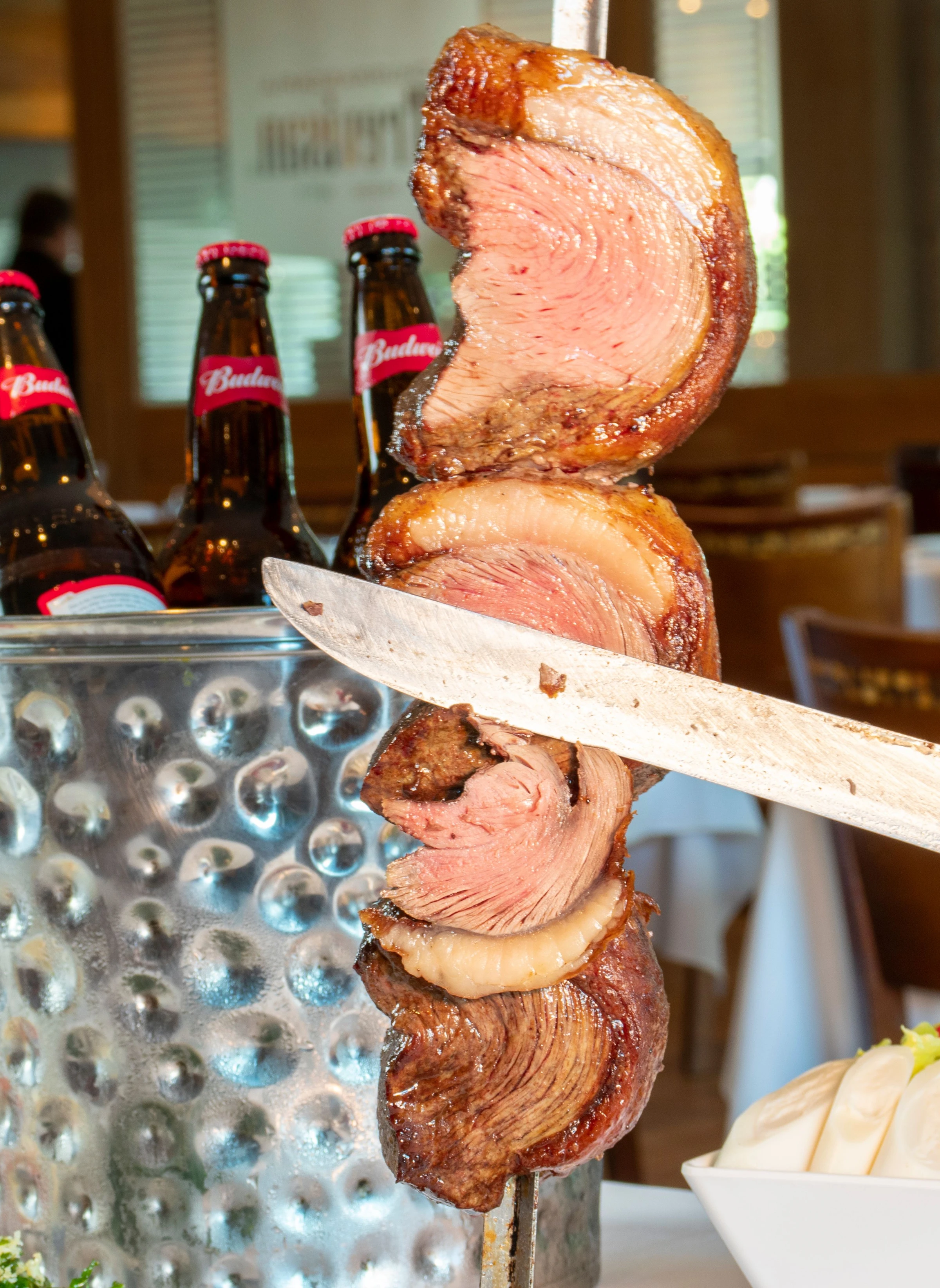 Savor the authentic taste of Brazilian churrasco with refreshing beers in a cozy São Paulo restaurant.