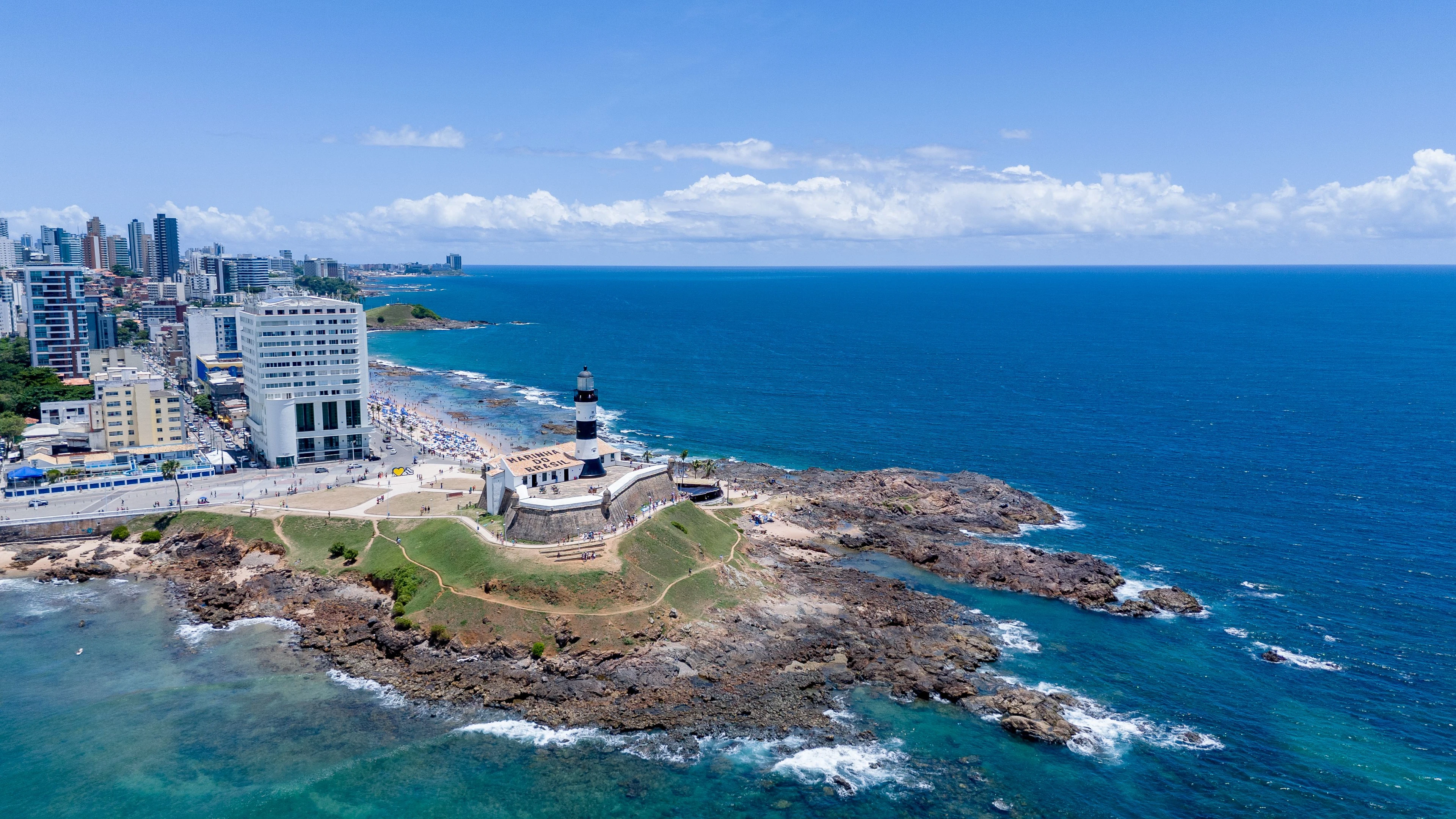 Barra lighthouse surrounded by blue Atlantic water and Salvador’s coast