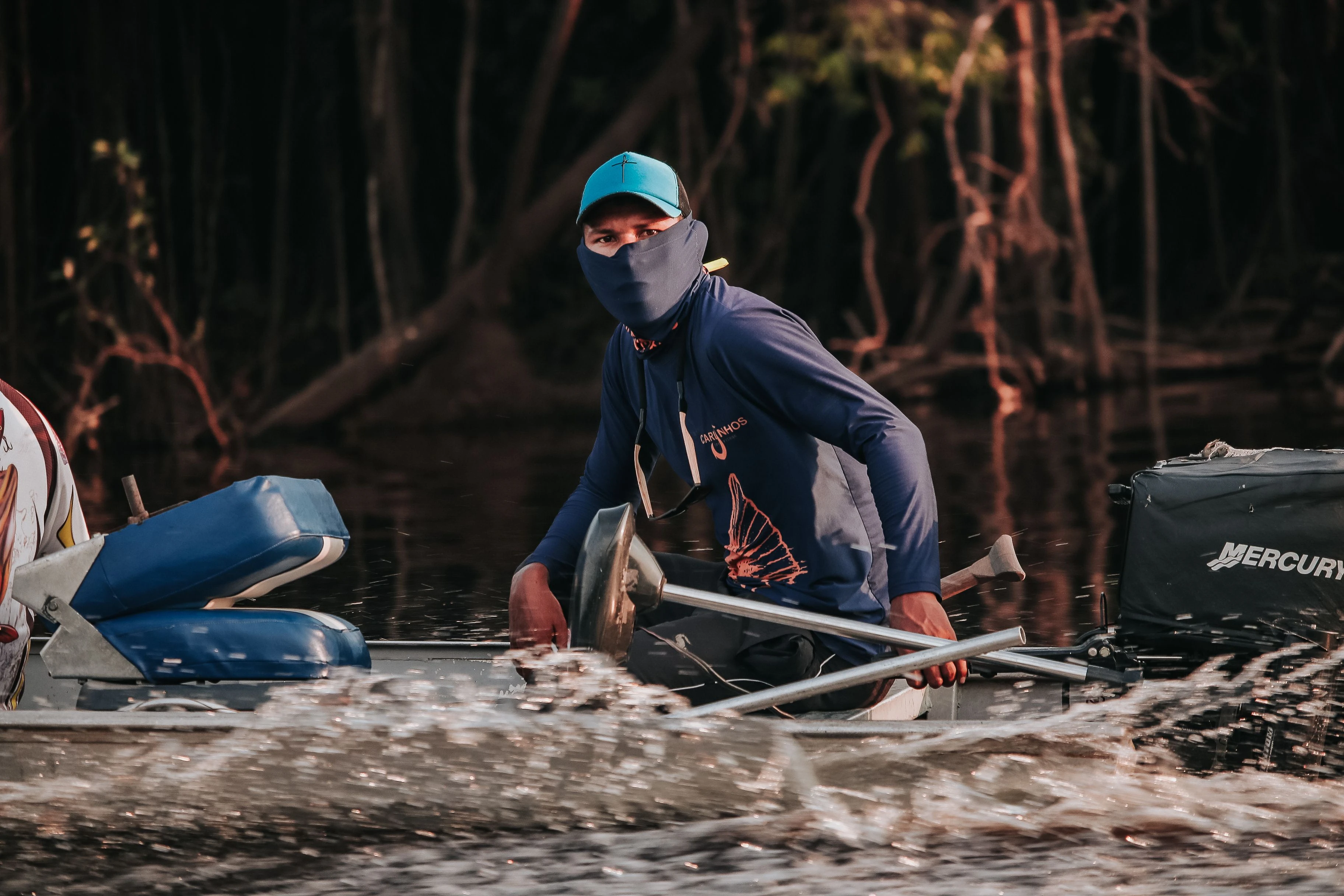A boat operator seen from water level on the Rio Negro at Manaus
