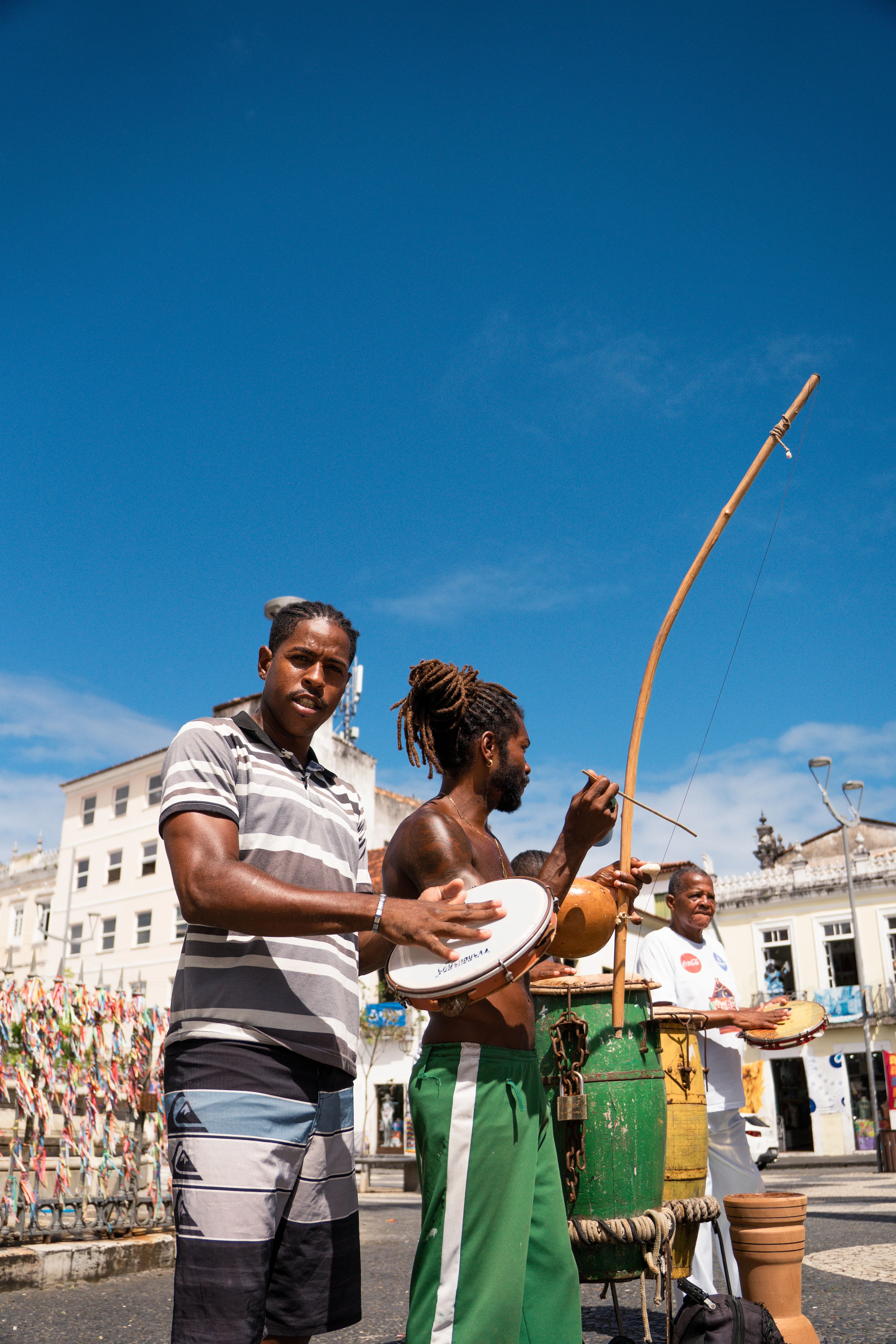 Musicians playing a berimbau, drum and pandeiro in Salvador