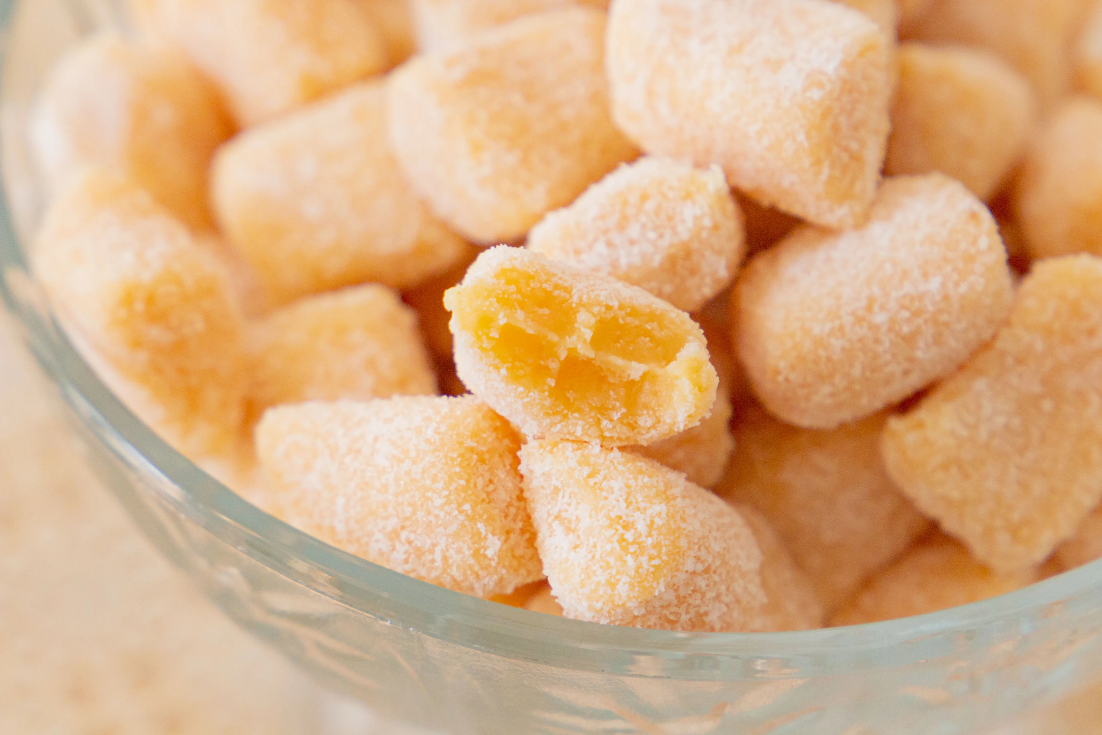 Sugar-coated passion fruit sweets in a glass bowl, photographed in São Luís