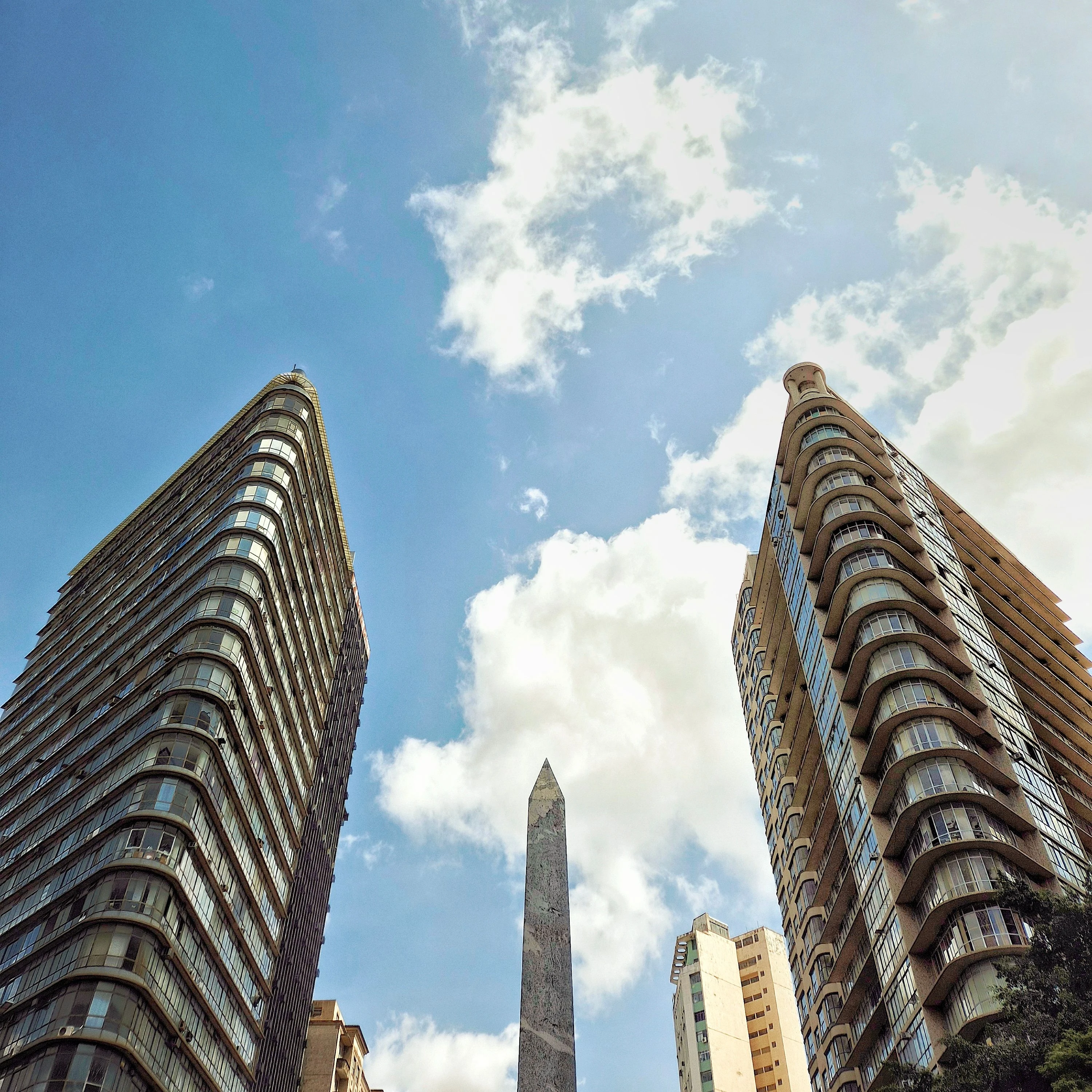Historic São Paulo buildings frame a monument and a blue sky
