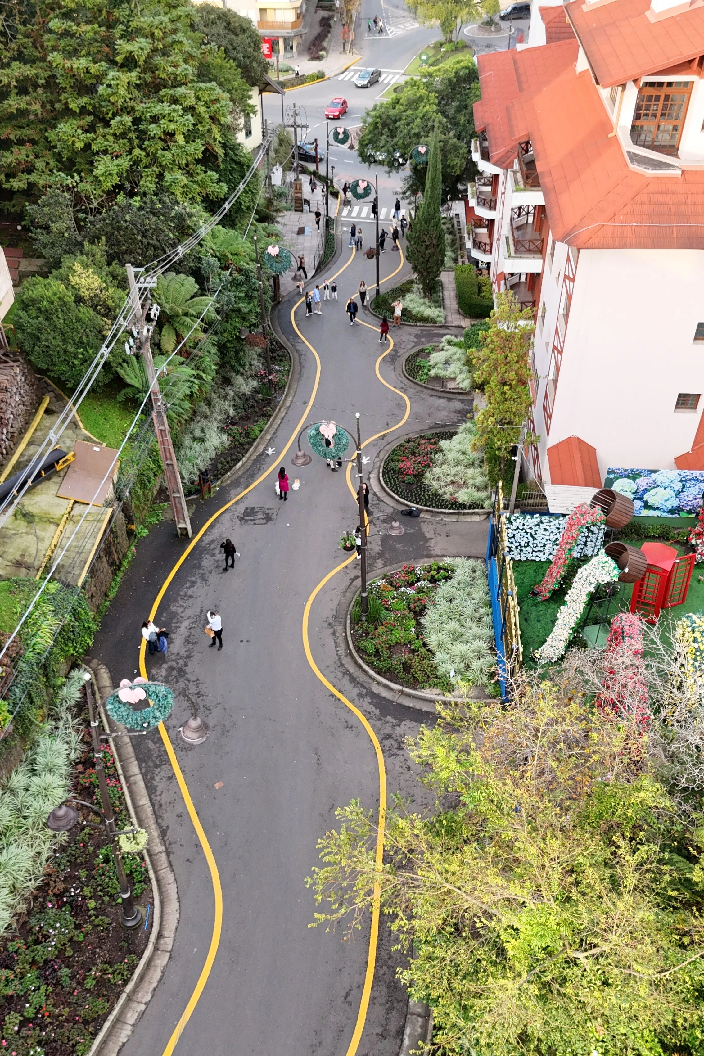 A winding street and red roofs give a high view of Gramado’s Rua Torta.
