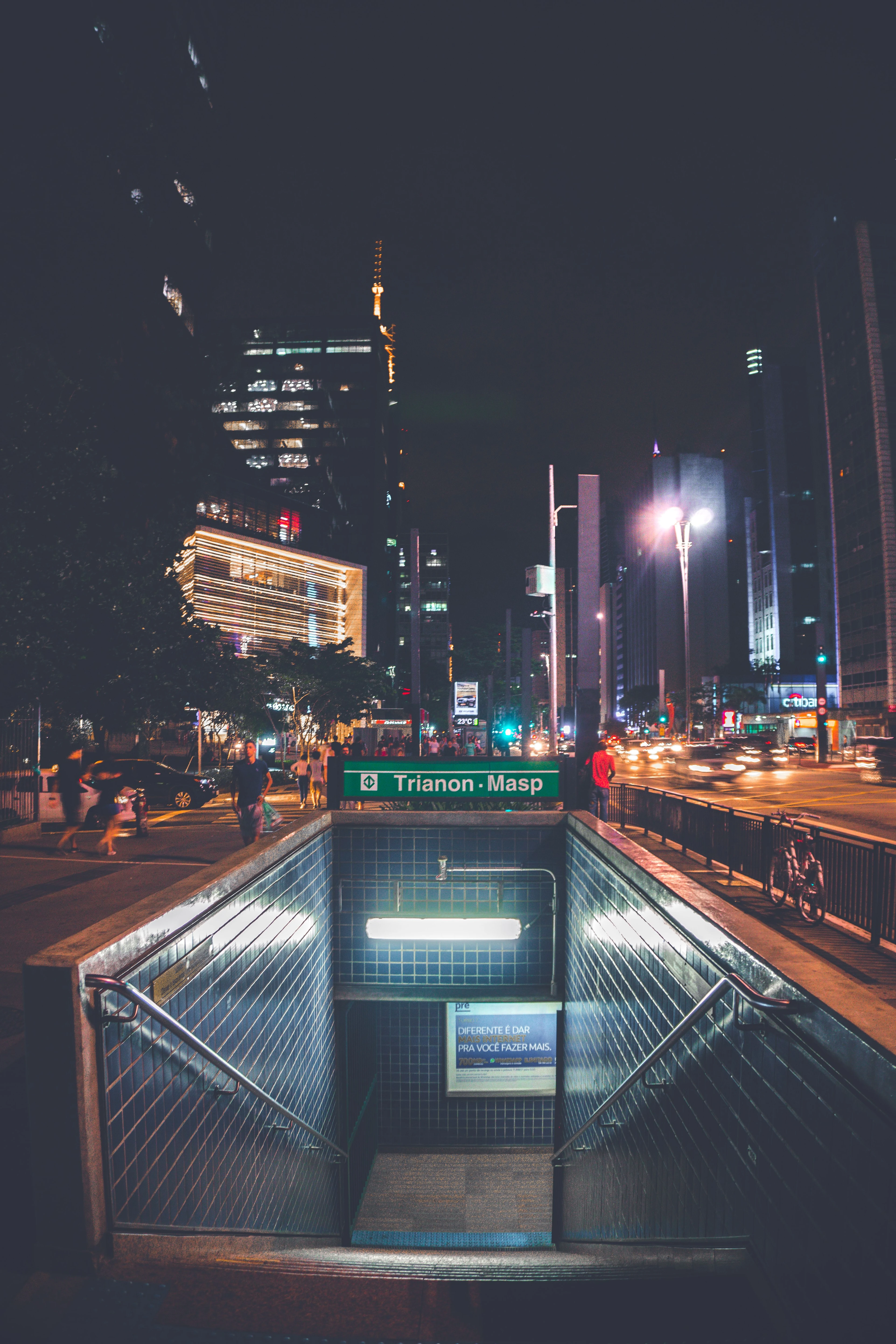 The Trianon-Masp station entrance illuminated among the evening lights of Paulista