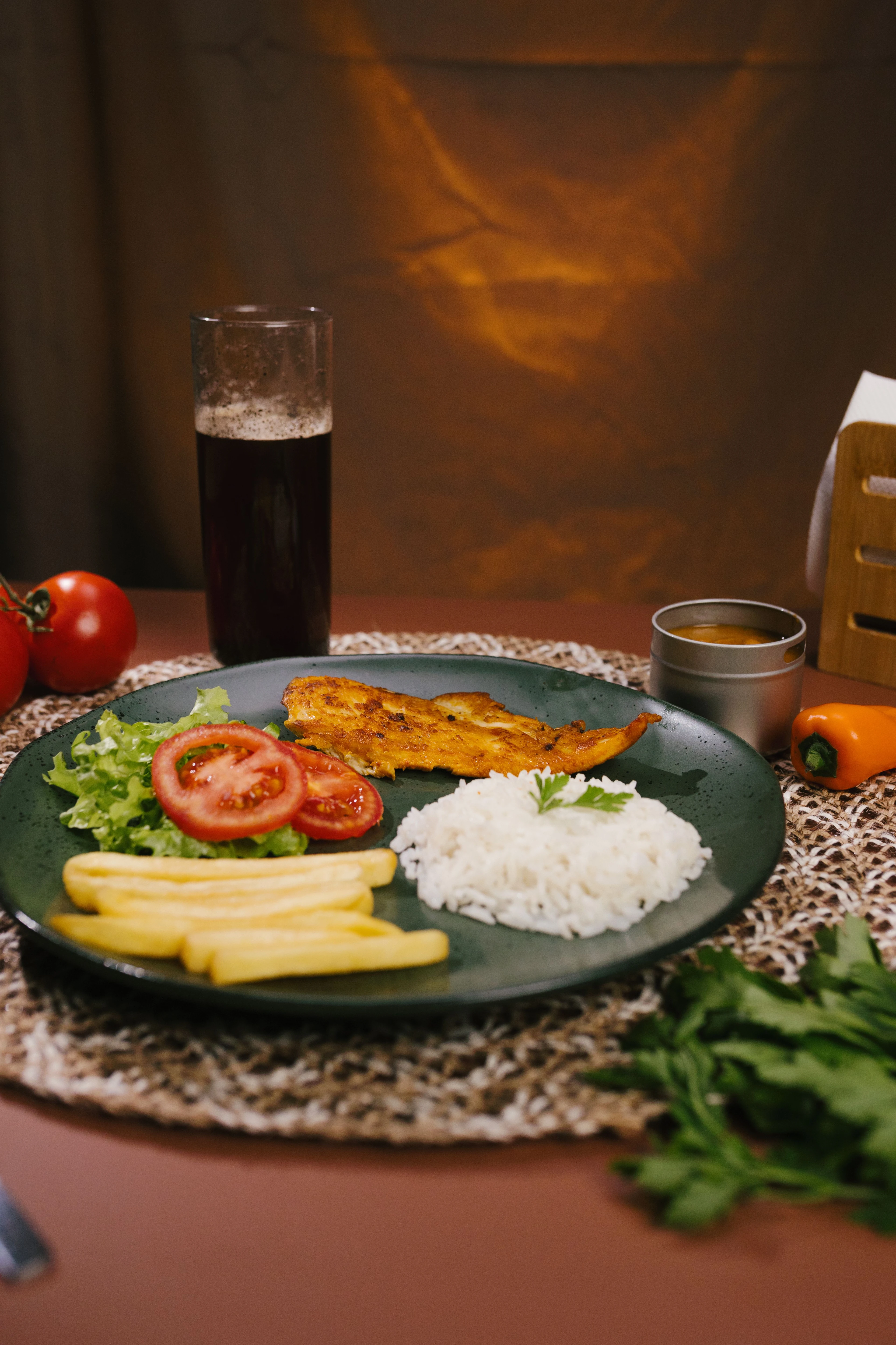 A Brazilian meal of fish, rice, fries and a colorful salad.