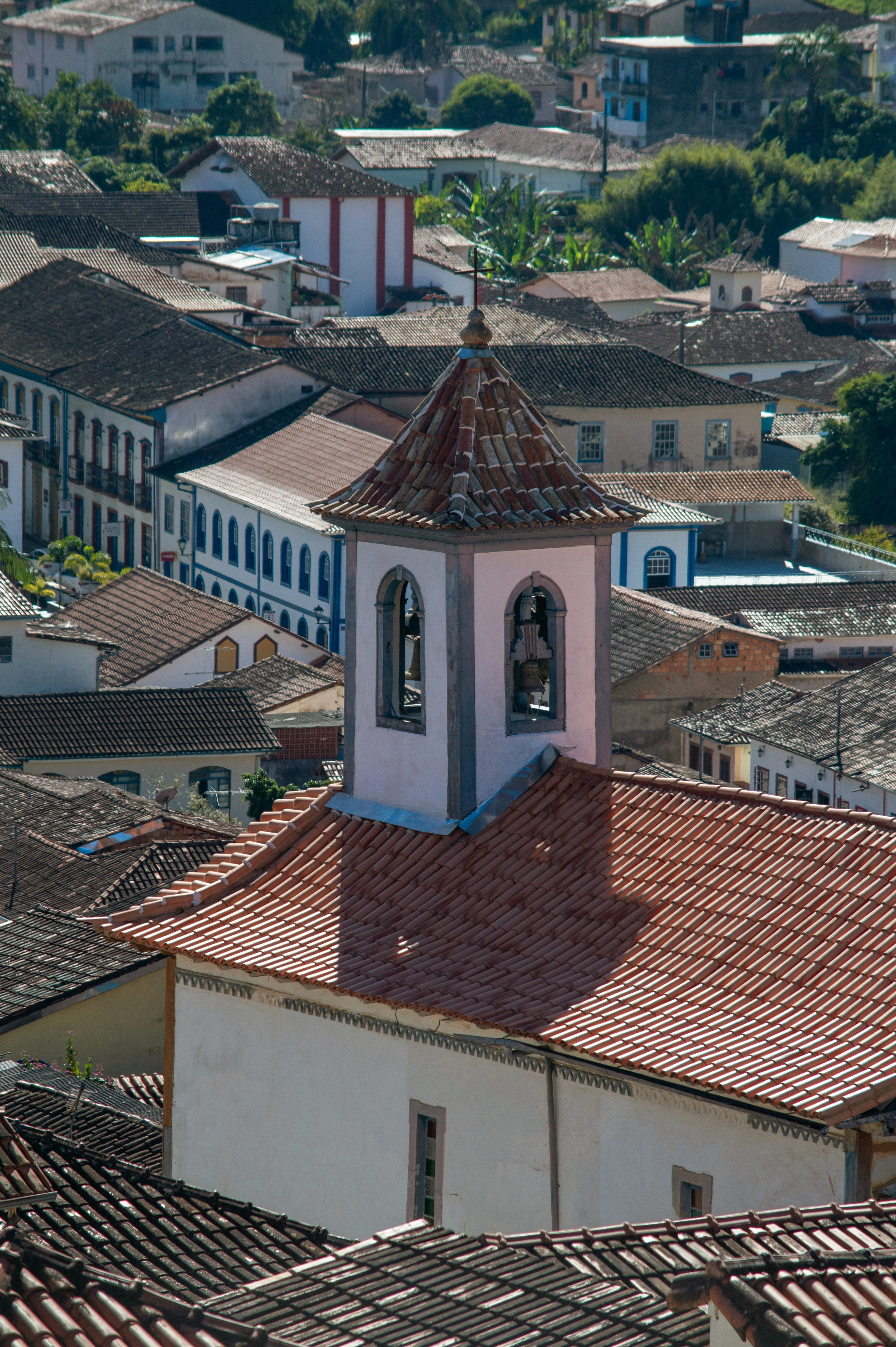 A telephoto view compresses Mariana's church tower and overlapping tiled roofs