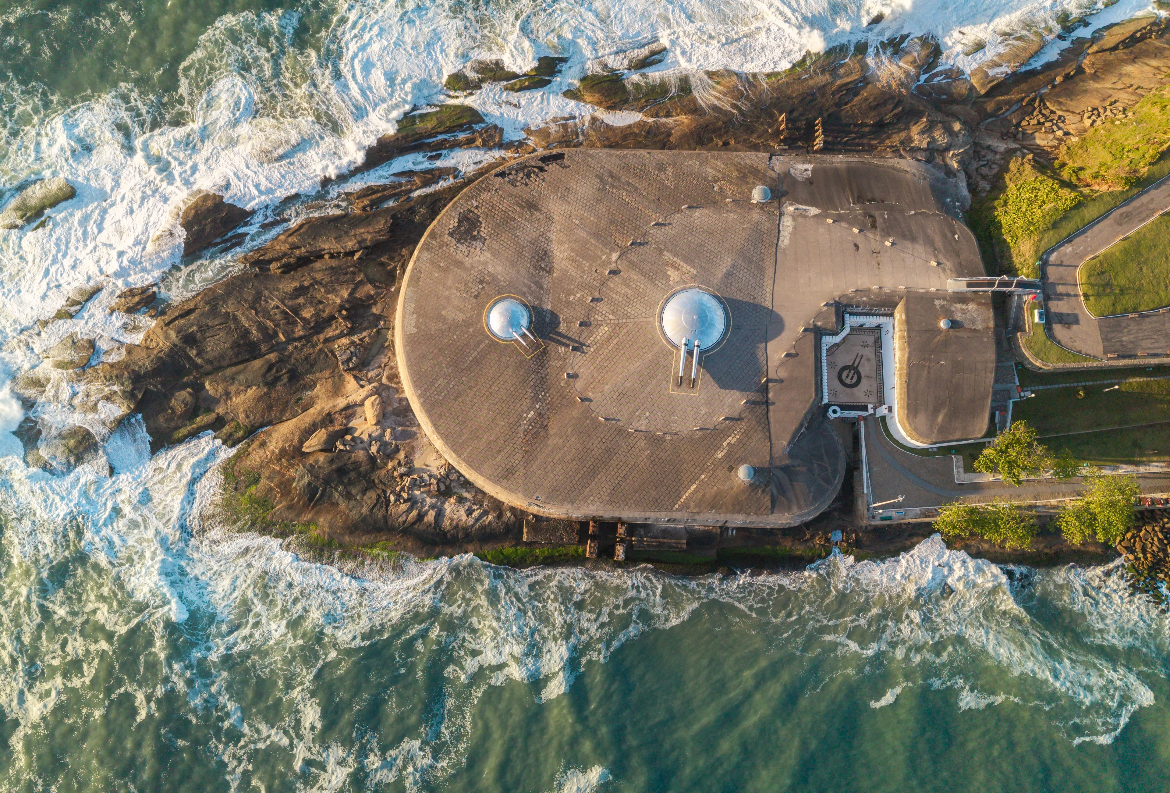 Waves break around Fort Copacabana in a directly overhead view of Rio de Janeiro
