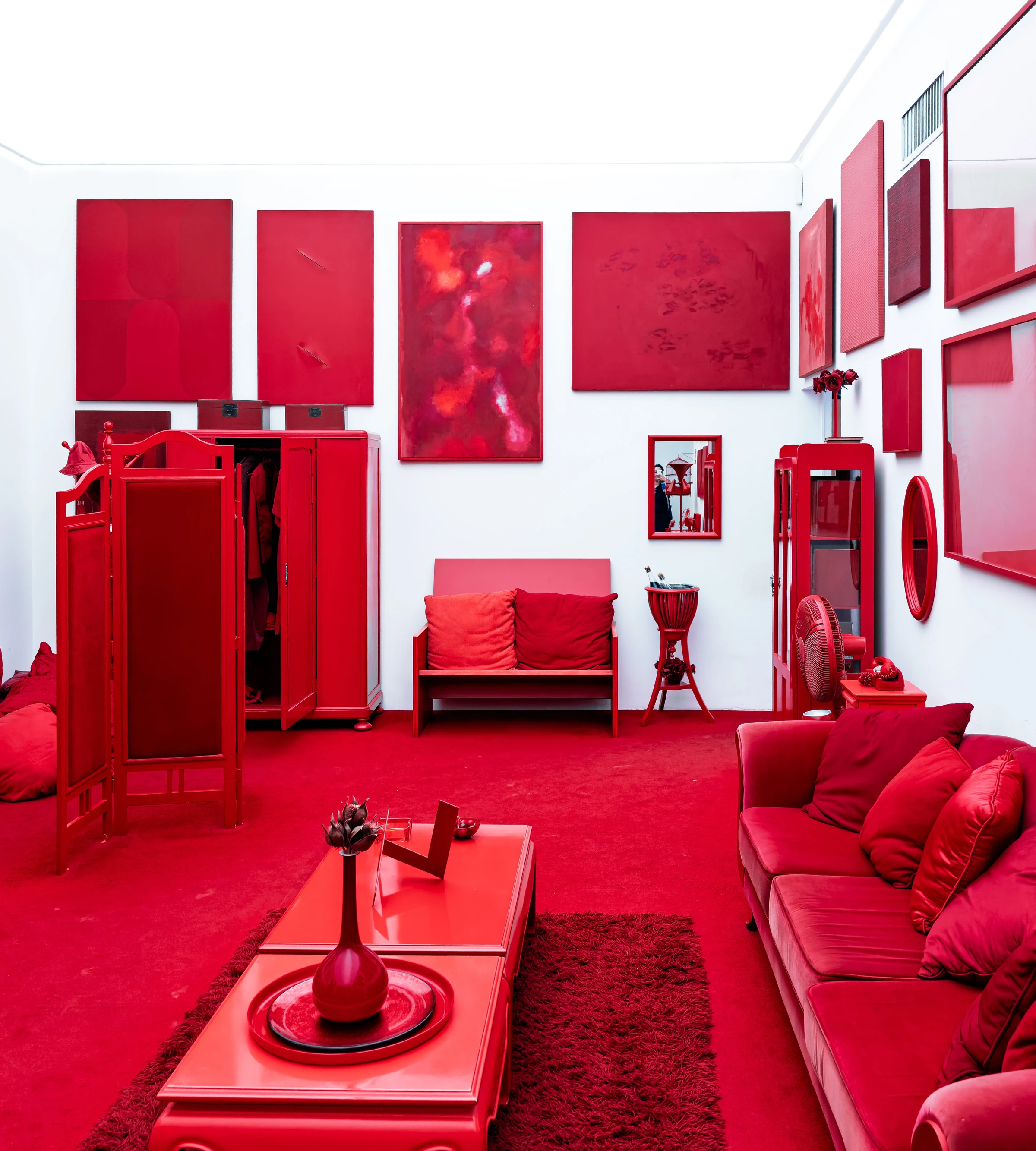 Red furniture and objects fill a vividly coloured art installation in Minas Gerais.