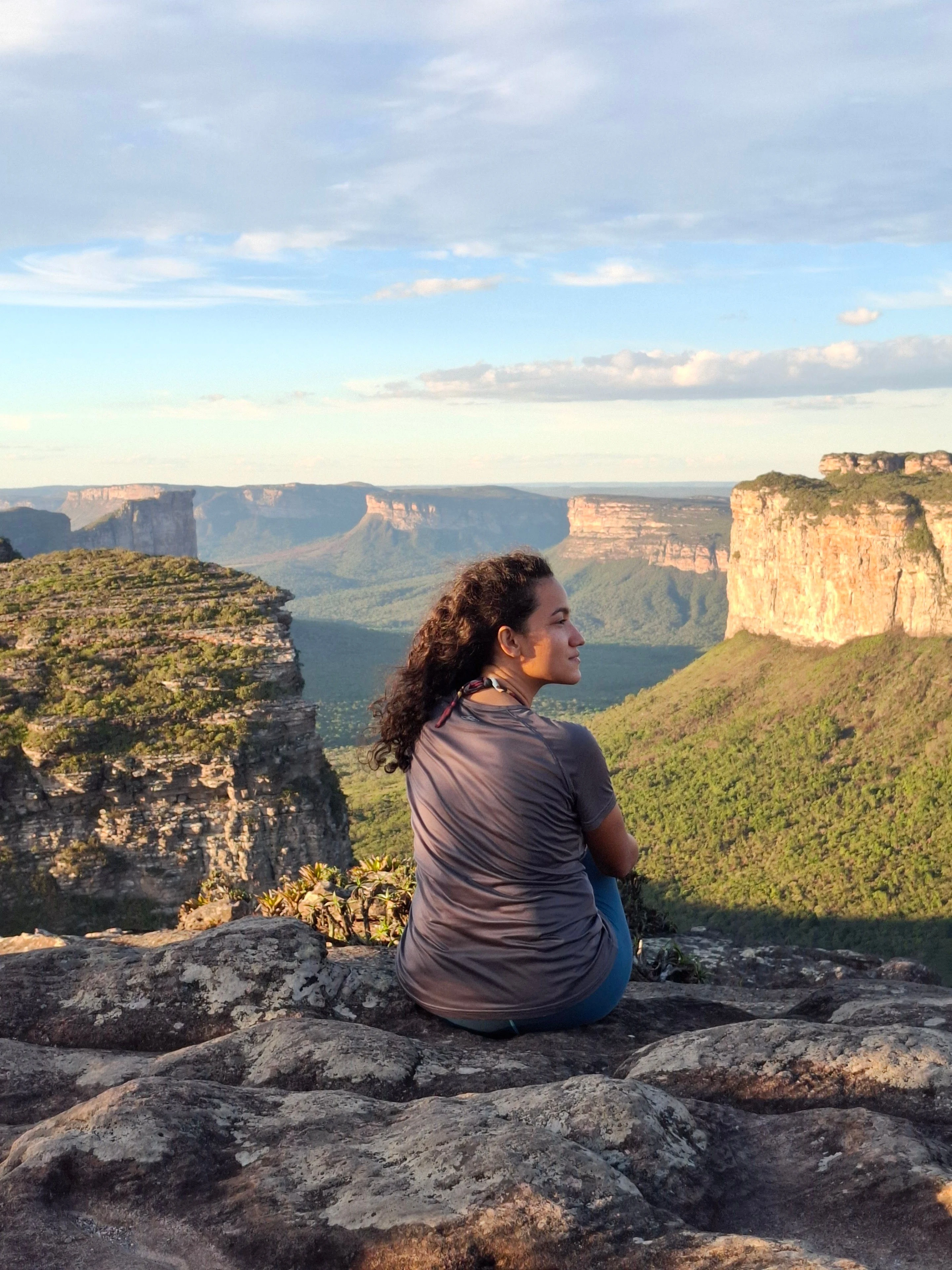 A hiker overlooking the warm sandstone cliffs of Chapada Diamantina
