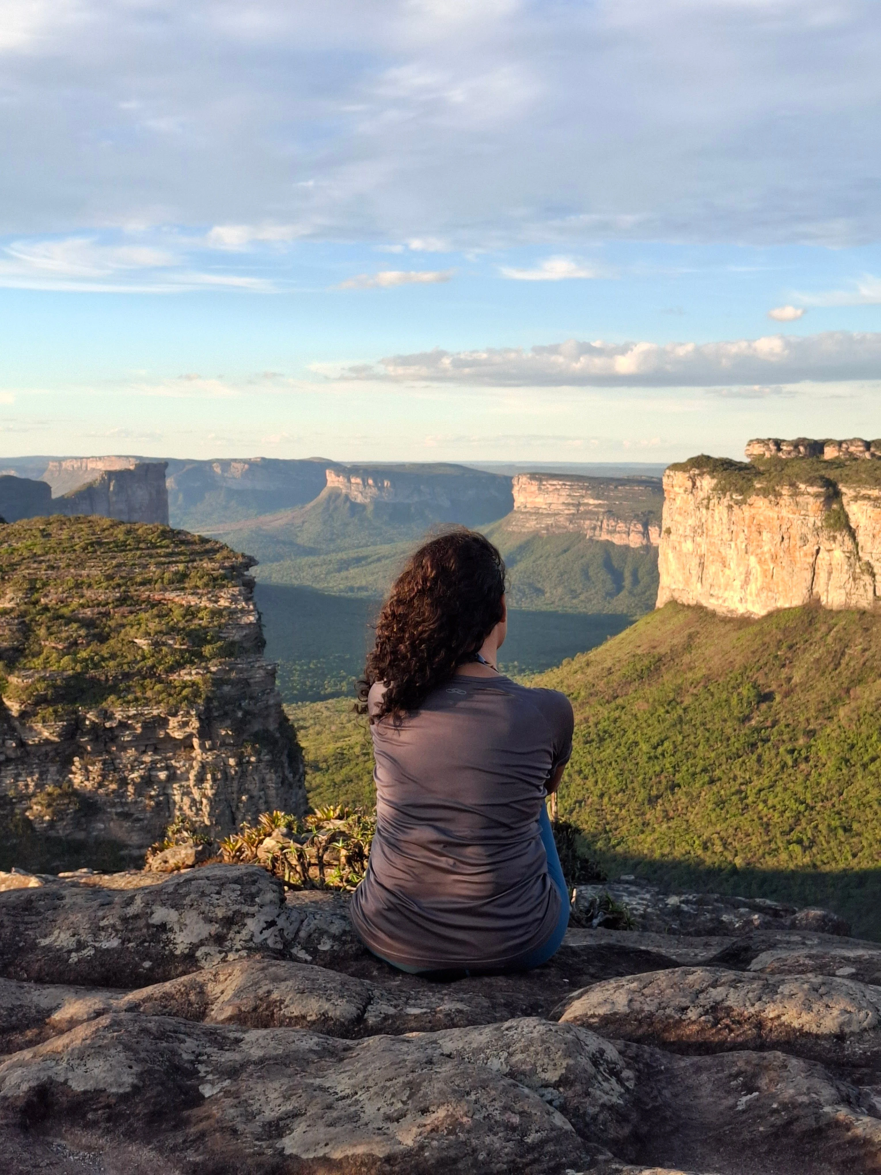 A hiker looking across deep valleys and cliffs in Chapada Diamantina