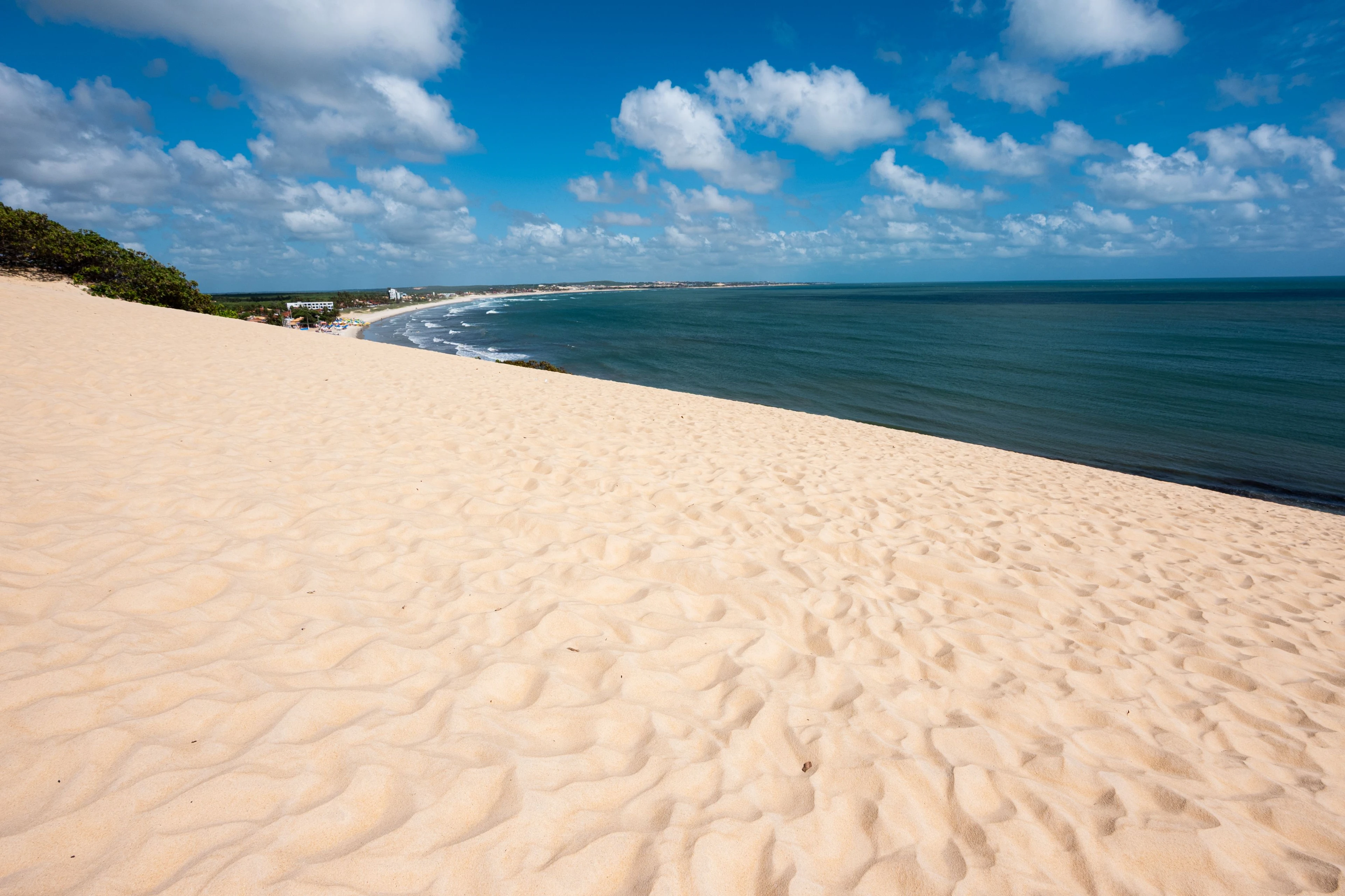 Pale sand dunes overlook the blue Atlantic coastline near Natal