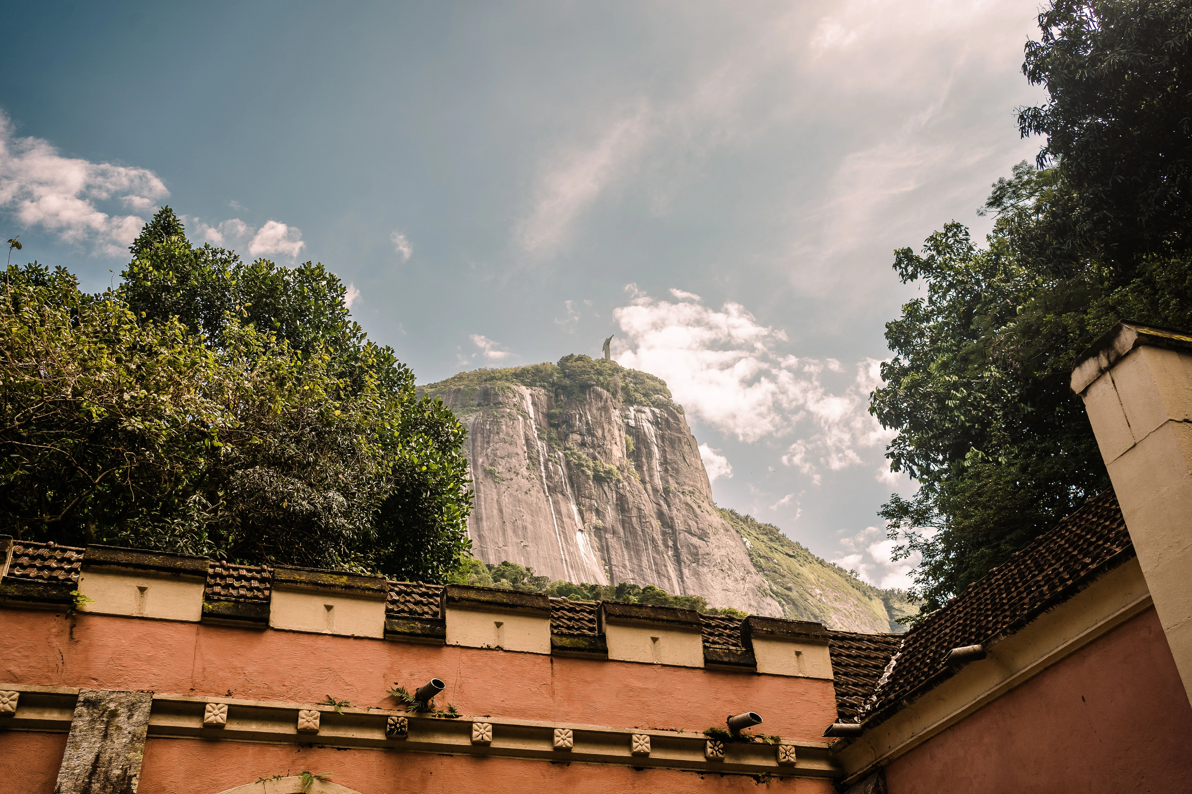Christ the Redeemer above rooftops and hills in Rio