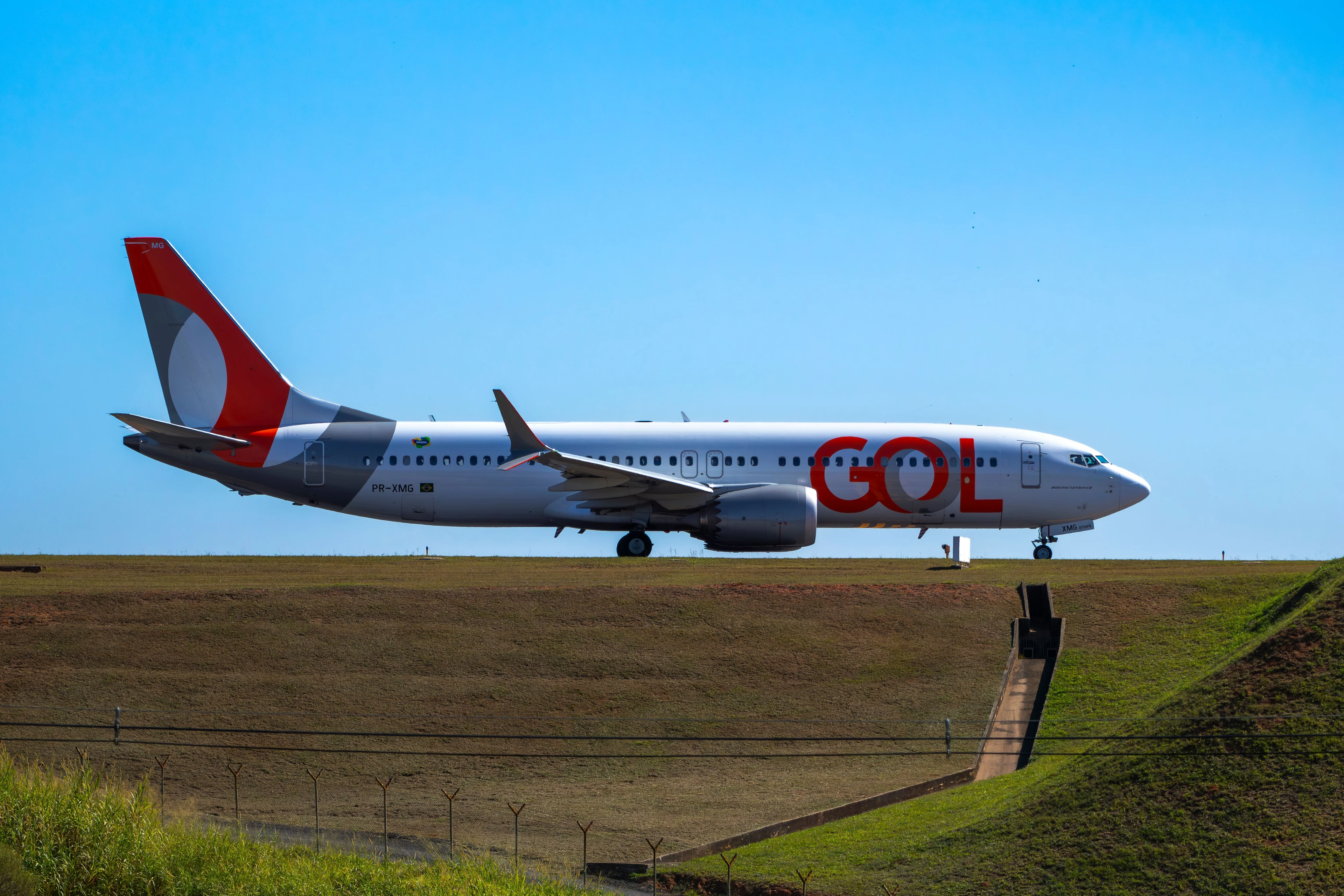 A GOL airliner on a Brazilian runway beneath a clear blue sky