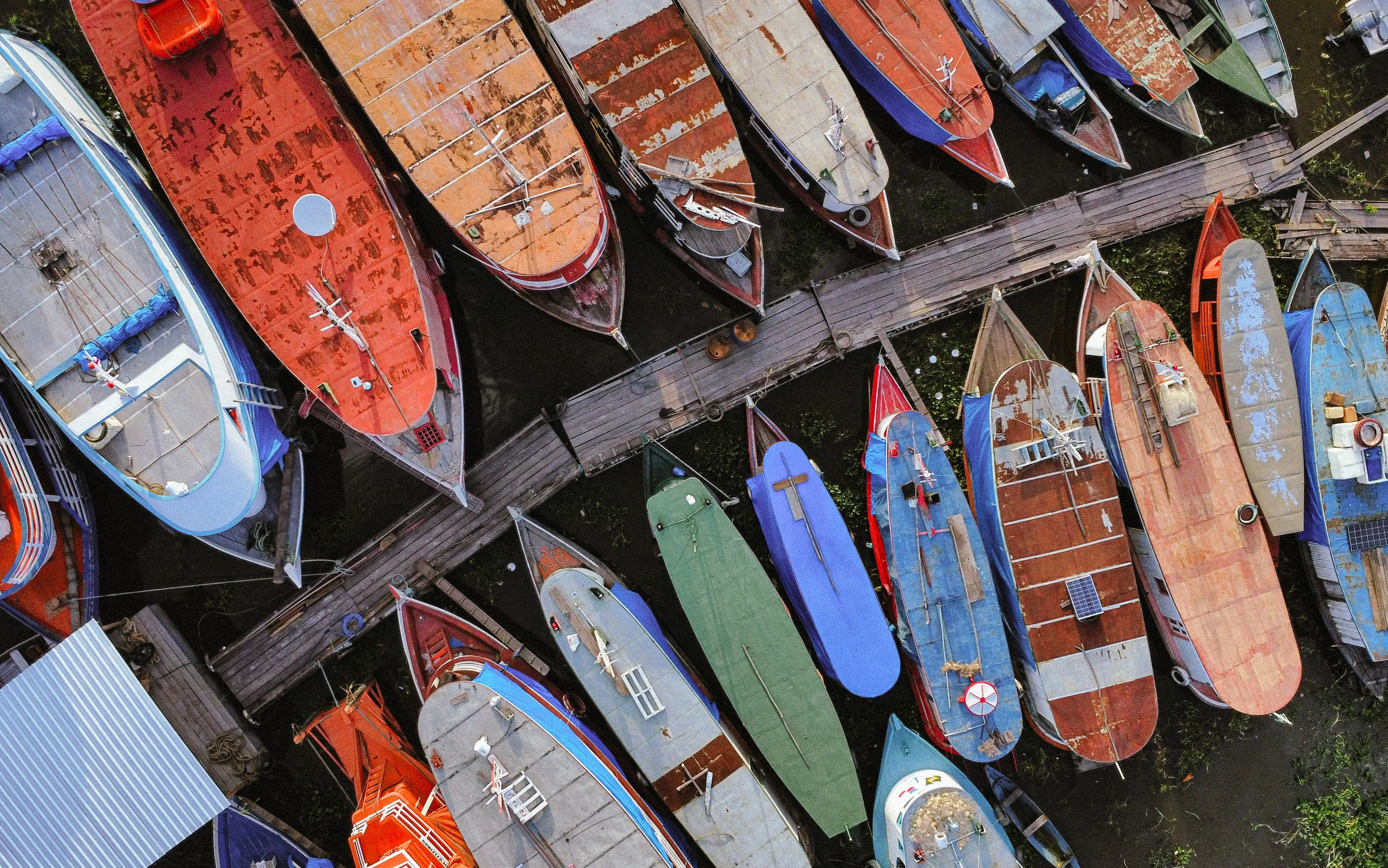 Colourful boats lie beside a wooden landing in Parintins, Amazonas.