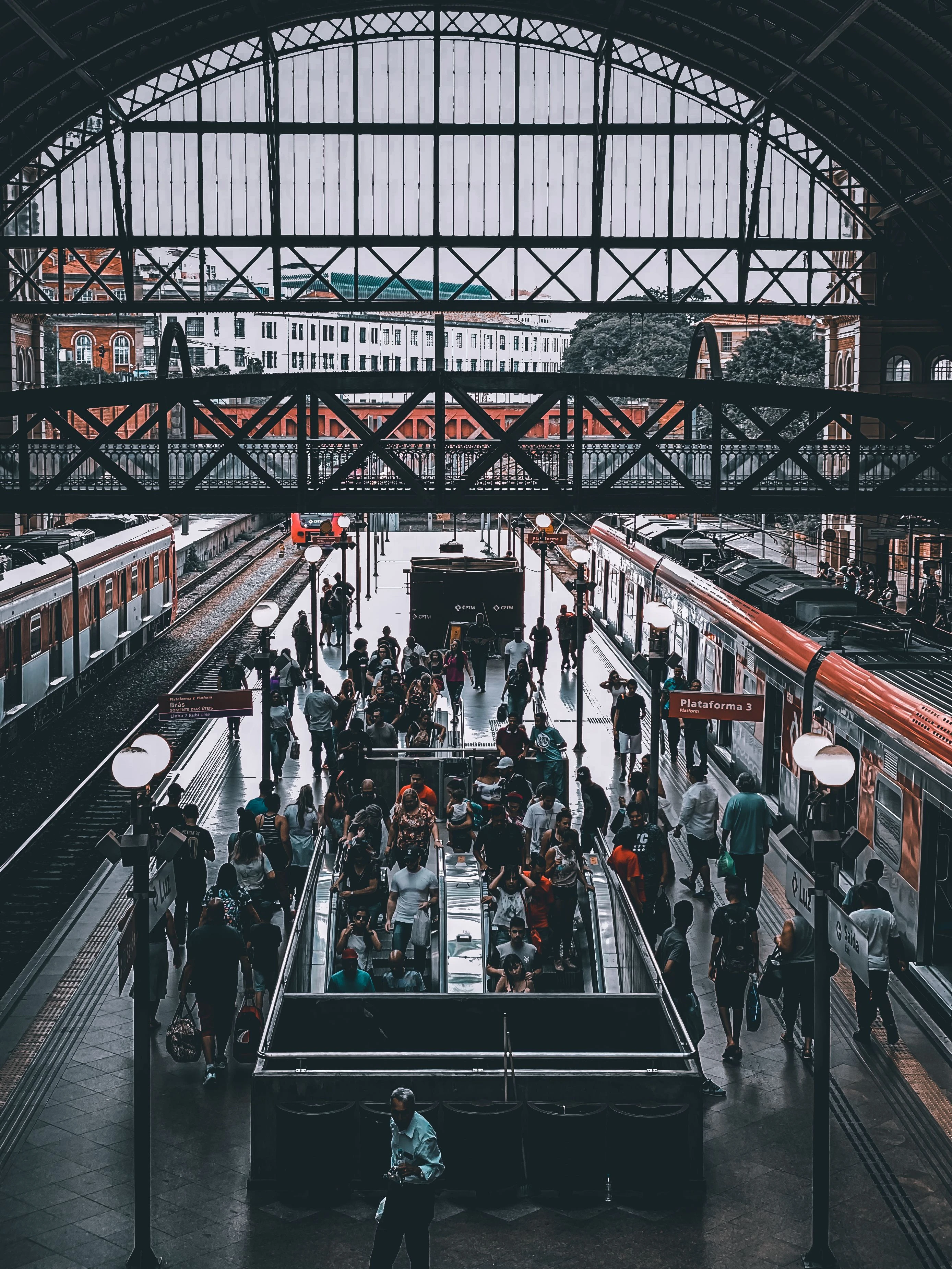 Commuters beneath the iron arches of Luz railway station