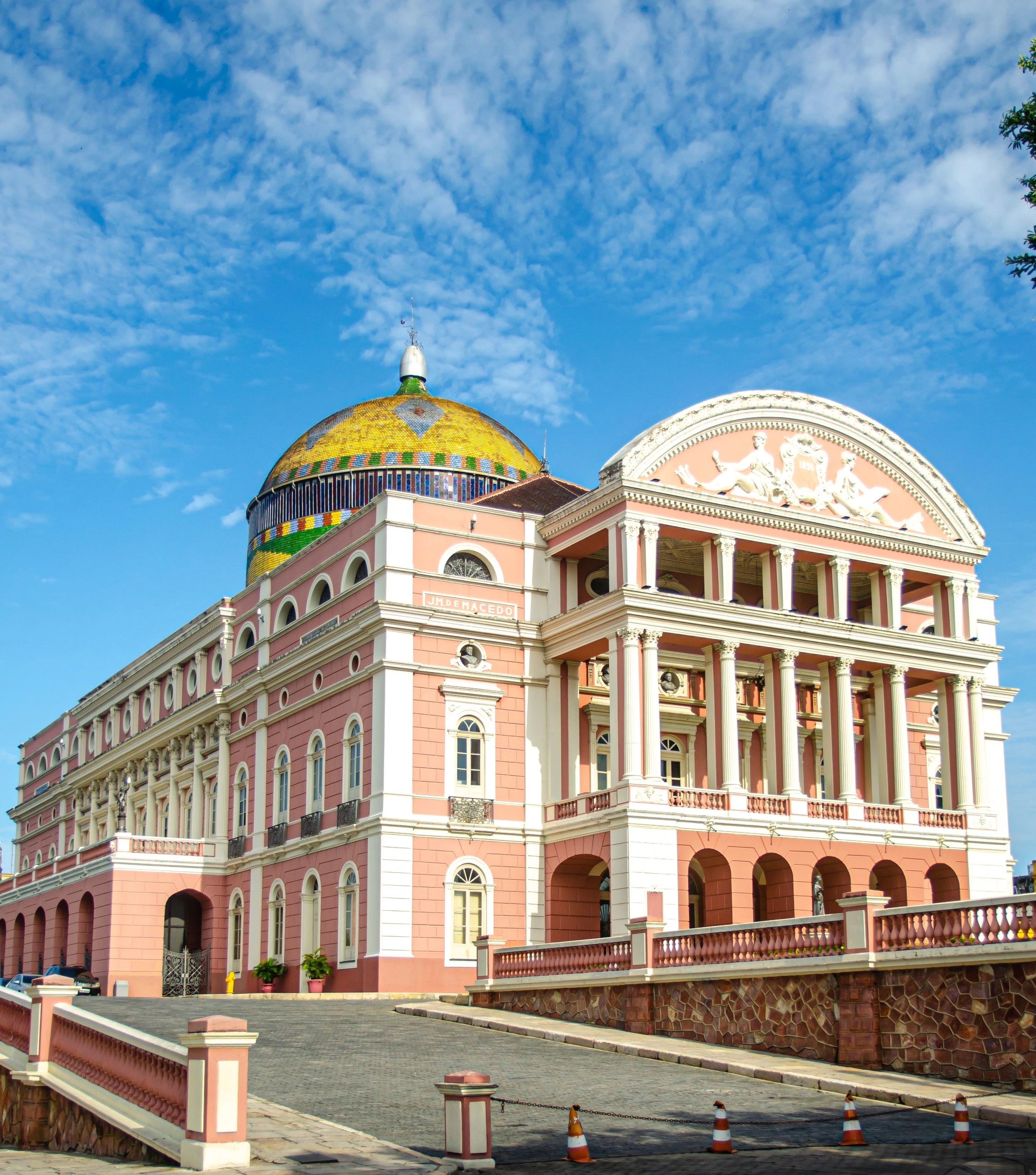 Pink theatre façade and patterned dome beneath a textured blue sky