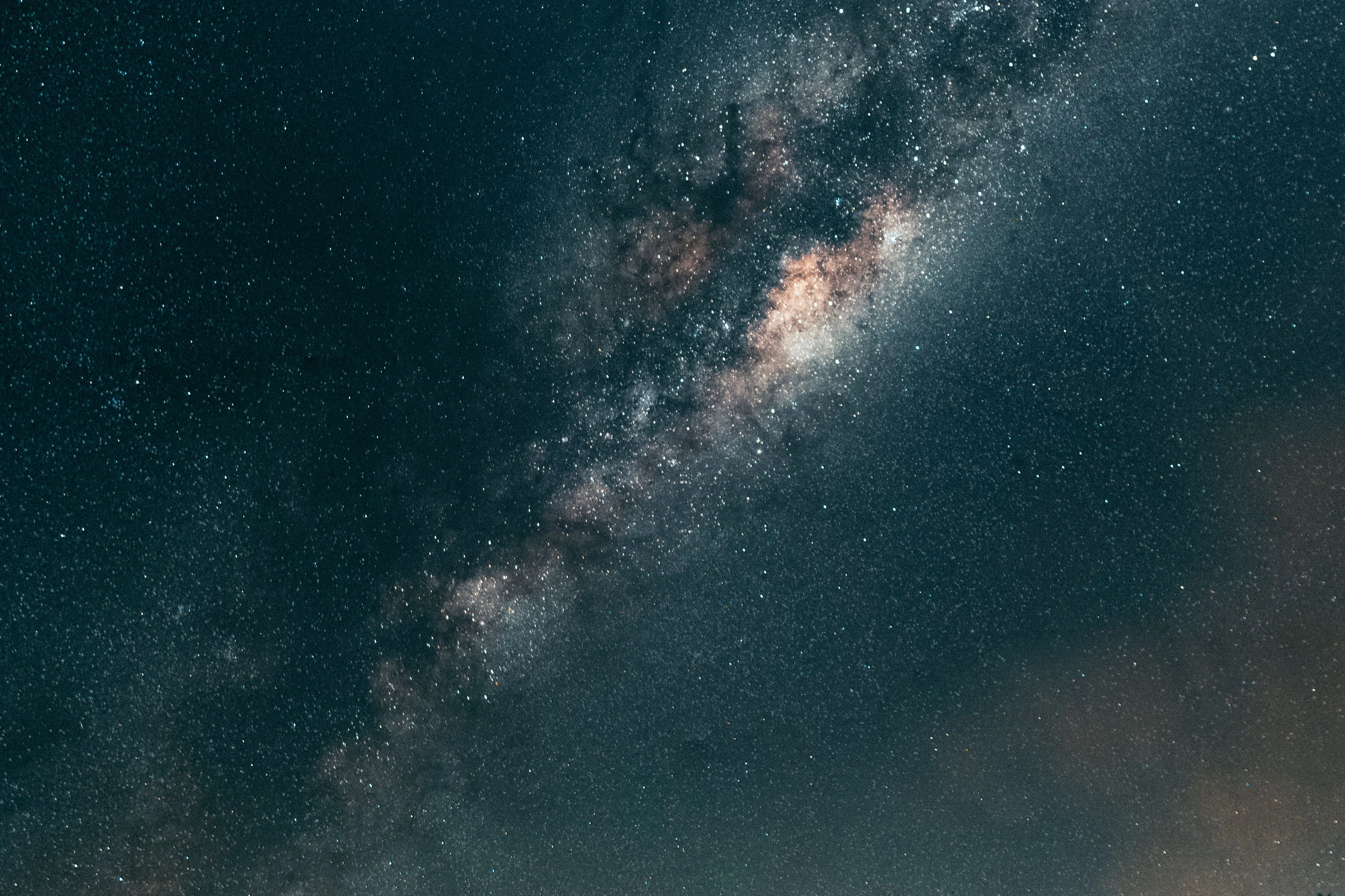 Stars and the Milky Way shine above a bridge in Canela.
