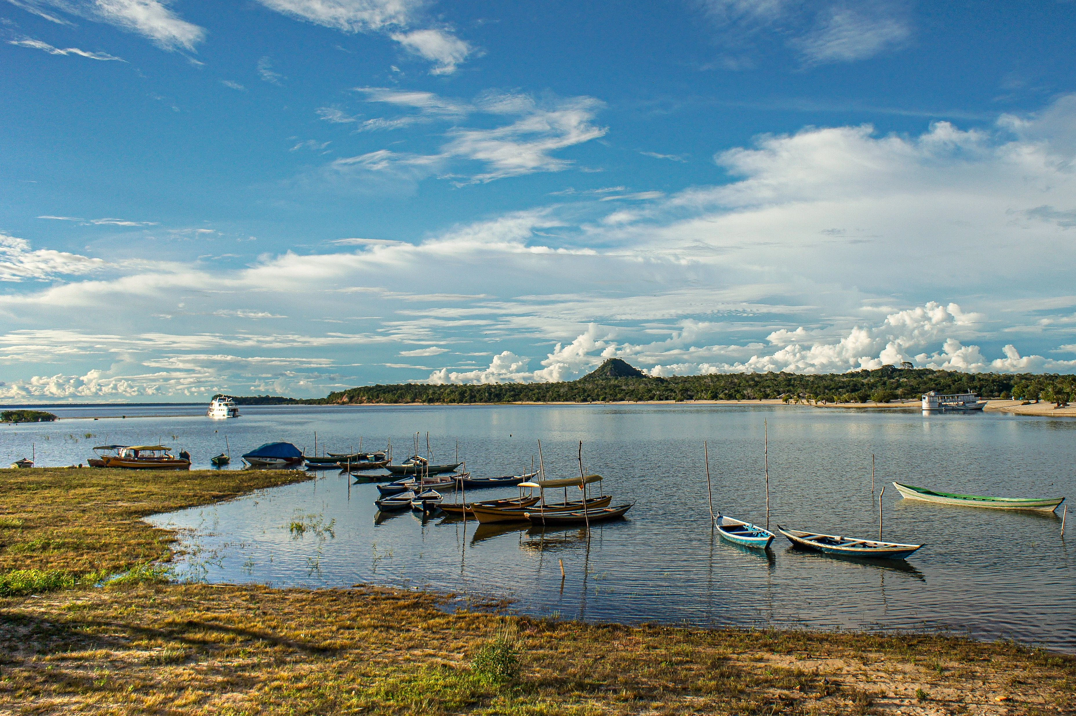 Blue wooden boats beside a sandy shoreline at Alter do Chão on the Tapajós