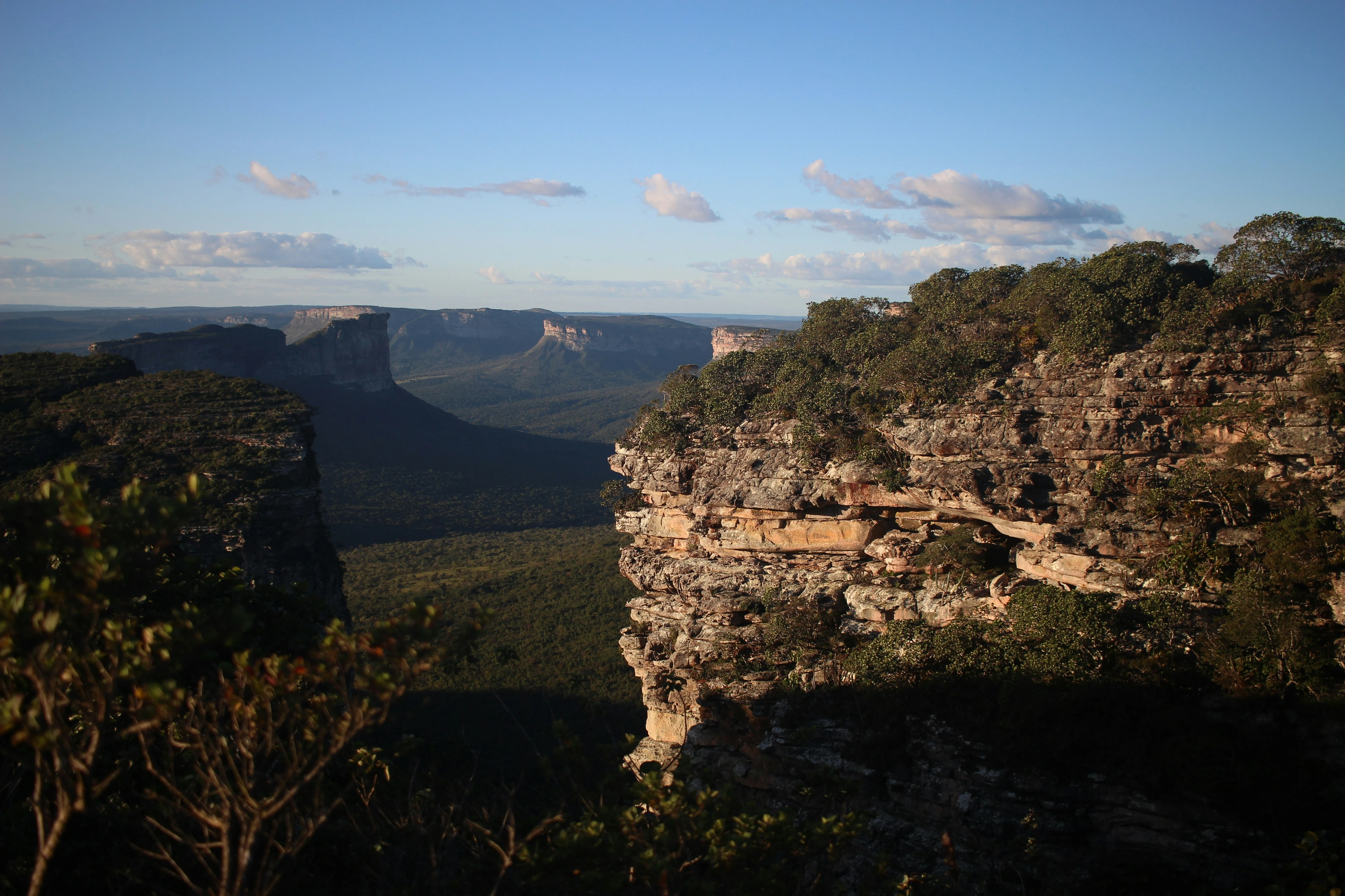 Warm sandstone cliffs and a valley in Chapada Diamantina