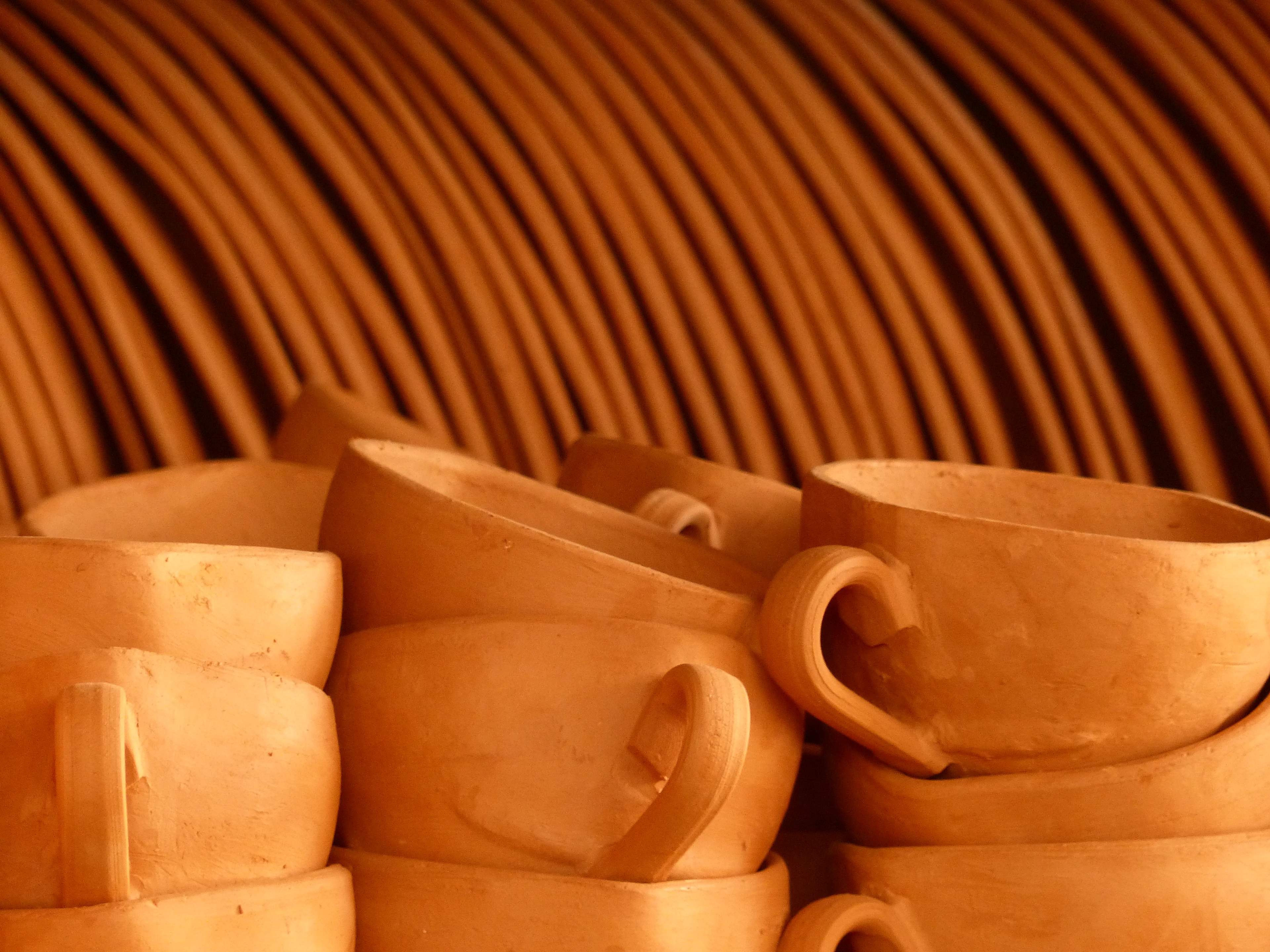 Unglazed clay cups and stacked plates at Cerâmica Serra da Capivara